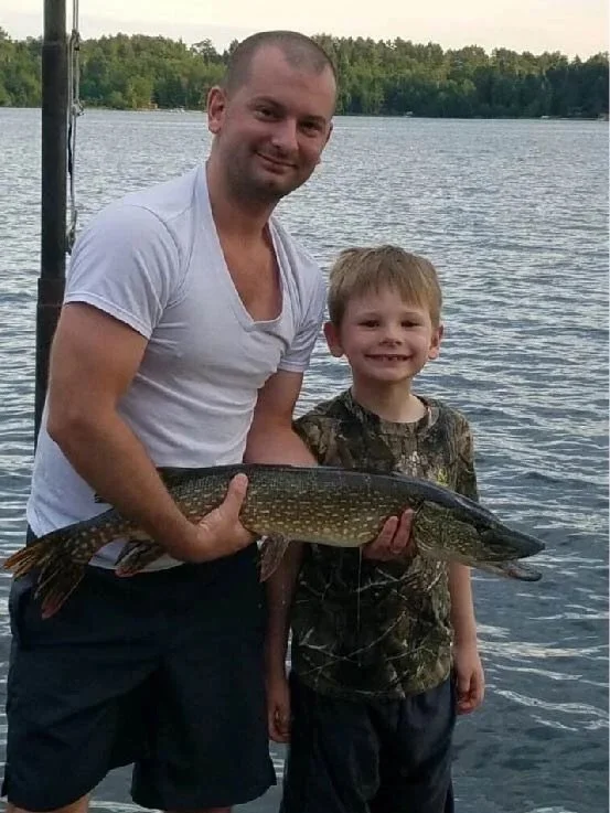 BWCA northern pike family catch Ely MN - Dad and son trophy pike hold Boundary Waters Arrowhead Outdoors report