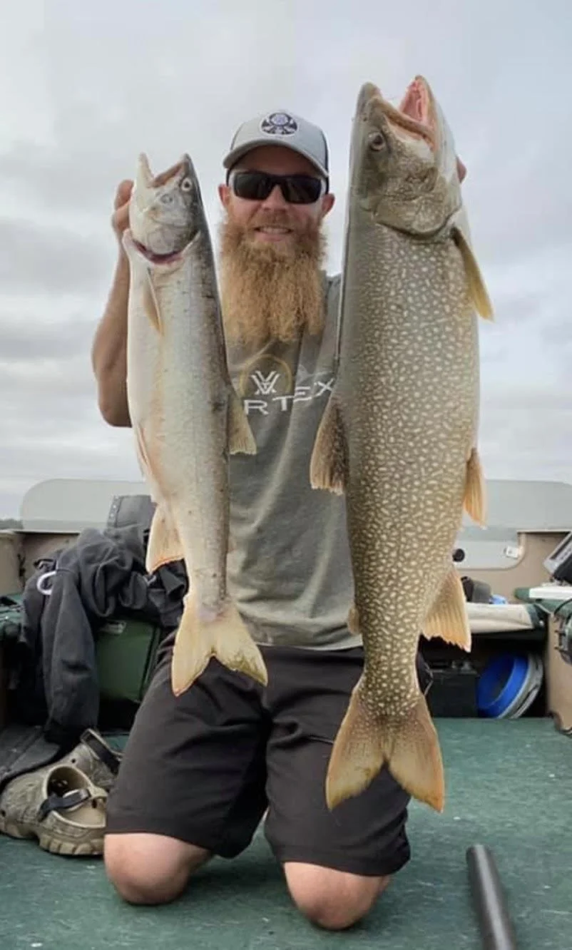 Angler holds double lake trout caught on trolling spoons in boat Ely MN, BWCA area, August 20 2024. Arrowhead Outdoors Ely MN fishing report with premium tackle, hunting gear & camping supplies available.