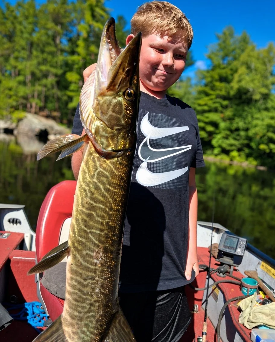 Young angler Alex with rare tiger muskie from White Iron Lake near Ely MN. Arrowhead Outdoors fishing report.