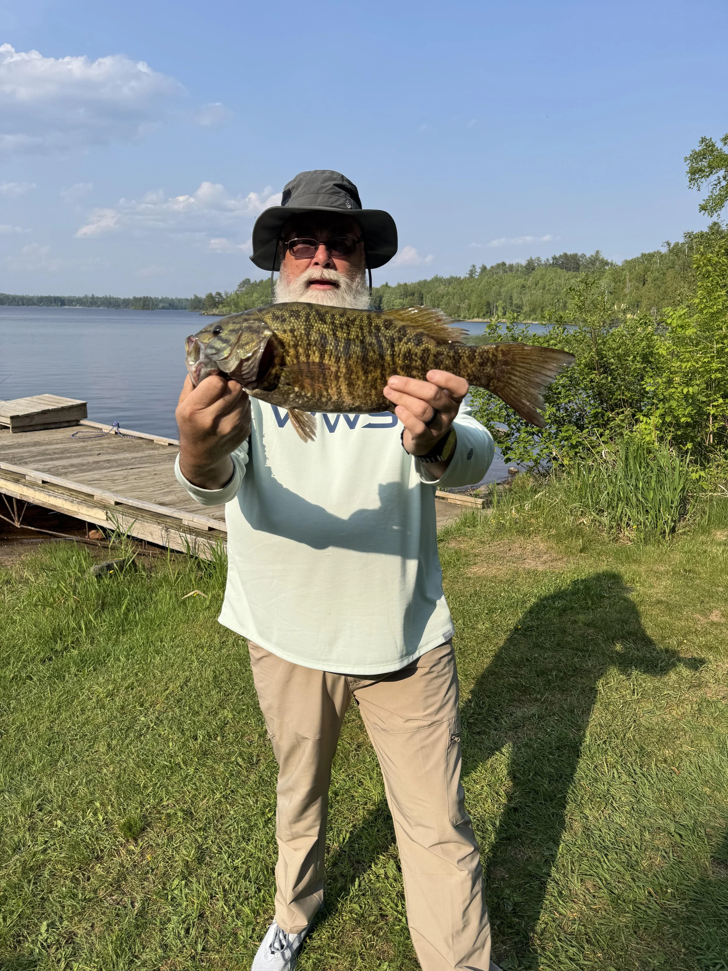 Angler holds trophy smallmouth bass on Strike King Spinnerbait July 15, 2025 in Ely MN BWCA. Summer report from Arrowhead Outdoors.
