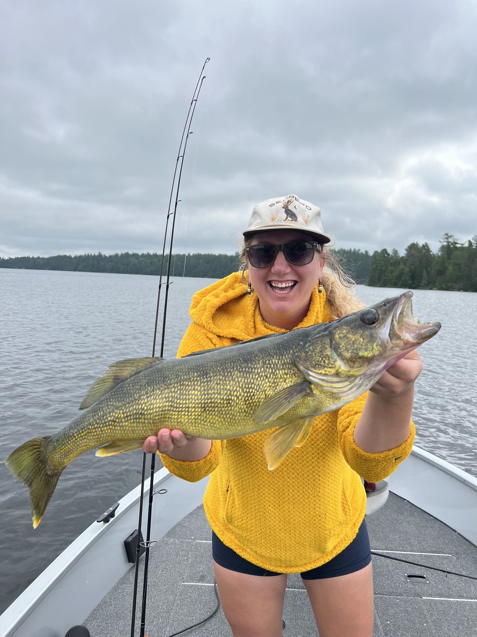 Angler holds walleye caught on nightcrawler in boat Ely MN, BWCA area, July 16 2024. Arrowhead Outdoors Ely MN fishing report with premium tackle, hunting gear & camping supplies available.
