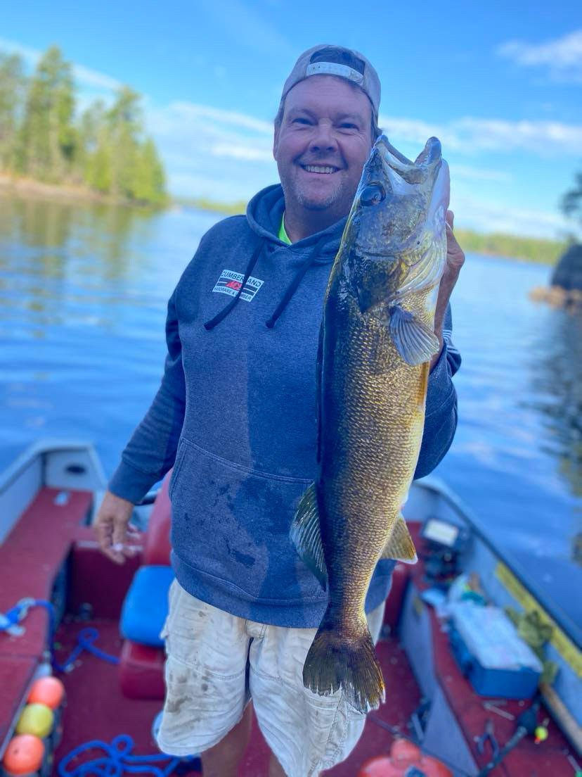 Angler holds trophy walleye caught on pike sucker in boat Ely MN, BWCA area, September 10 2024. Arrowhead Outdoors Ely MN fishing report with premium tackle, hunting gear & camping supplies available.