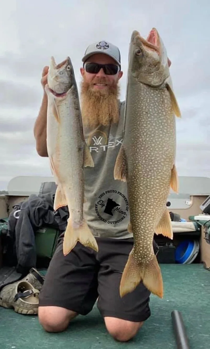 Ely MN BWCA lake trout open water catch Aug 28 2021, angler holding two big speckled lakers on boat deck, Arrowhead Outdoors report
