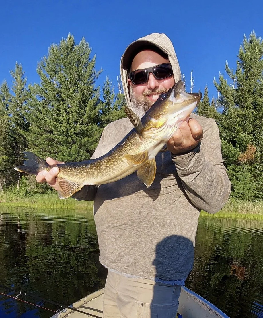 Angler holds walleye caught on leech in boat Ely MN, BWCA area, July 2 2024. Arrowhead Outdoors Ely MN fishing report with premium tackle, hunting gear & camping supplies available.