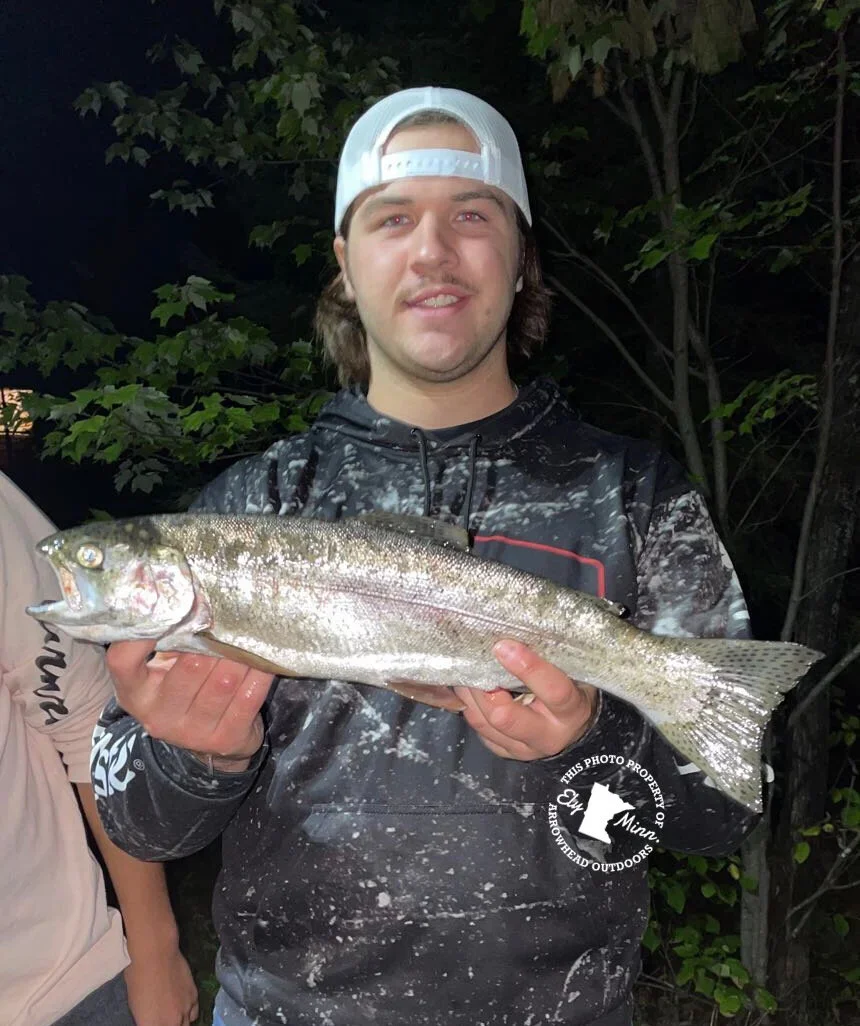 Ely MN BWCA rainbow trout open water catch Sep 8 2021, young angler holding chrome rainbow at night by shore, Arrowhead Outdoors report