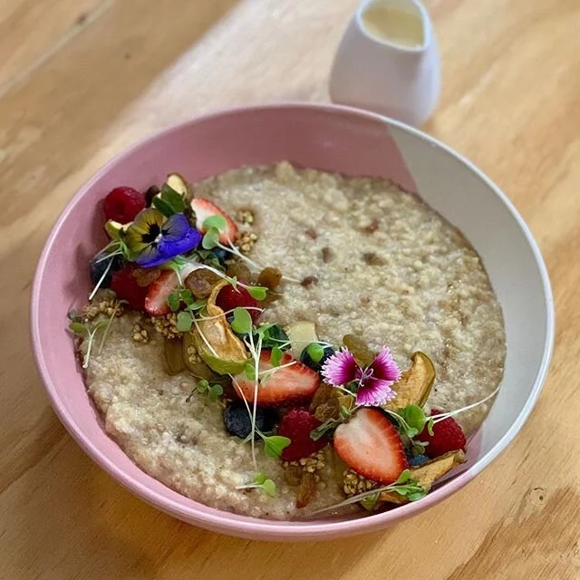 New menu feels. Our 3 grain porridge w poached apple, buchinis, berries & goats milk anglaise 💕