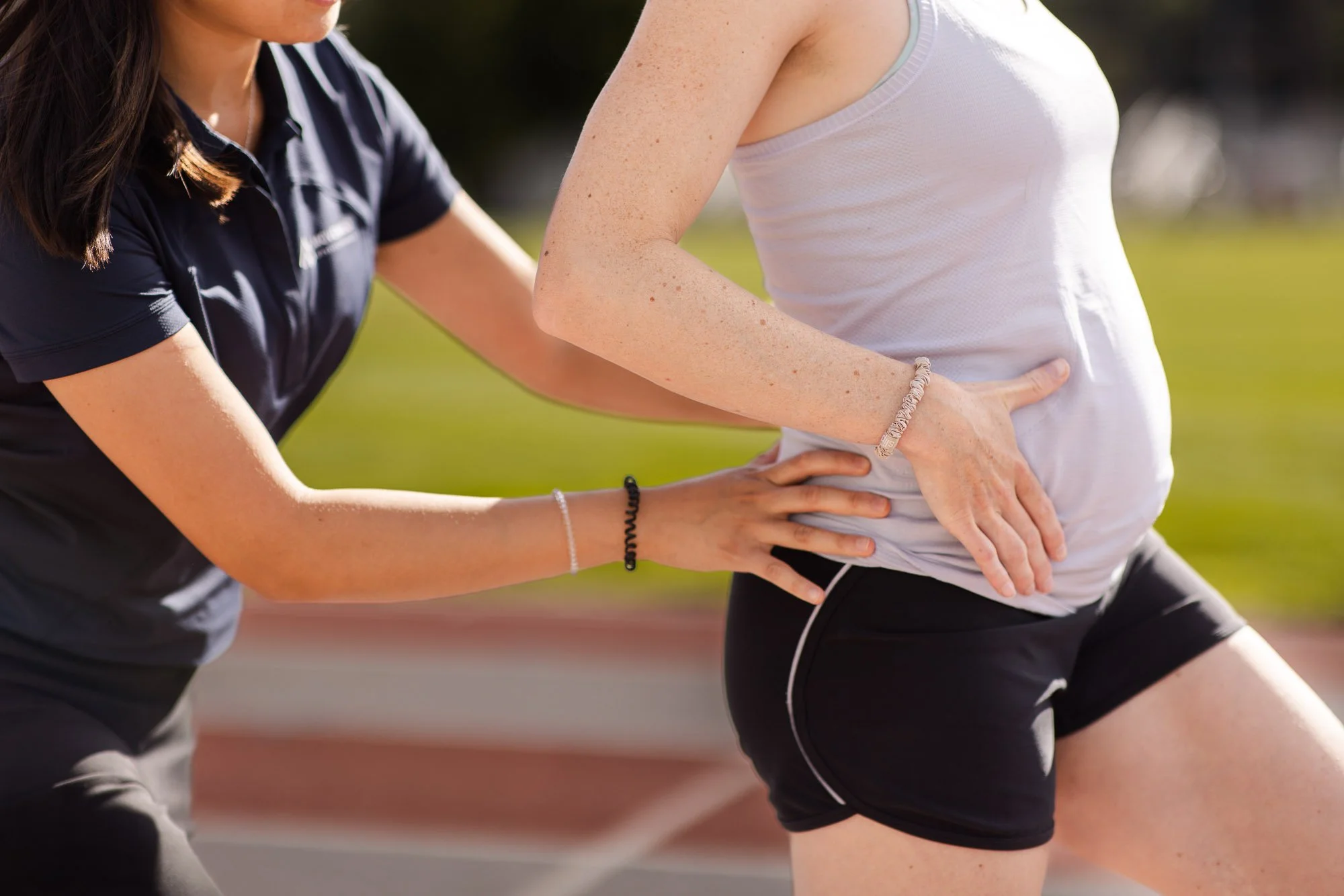 Kelowna physiotherapist adjusting a preganant woman's running posture to improve performance and acheive their movememnt goals