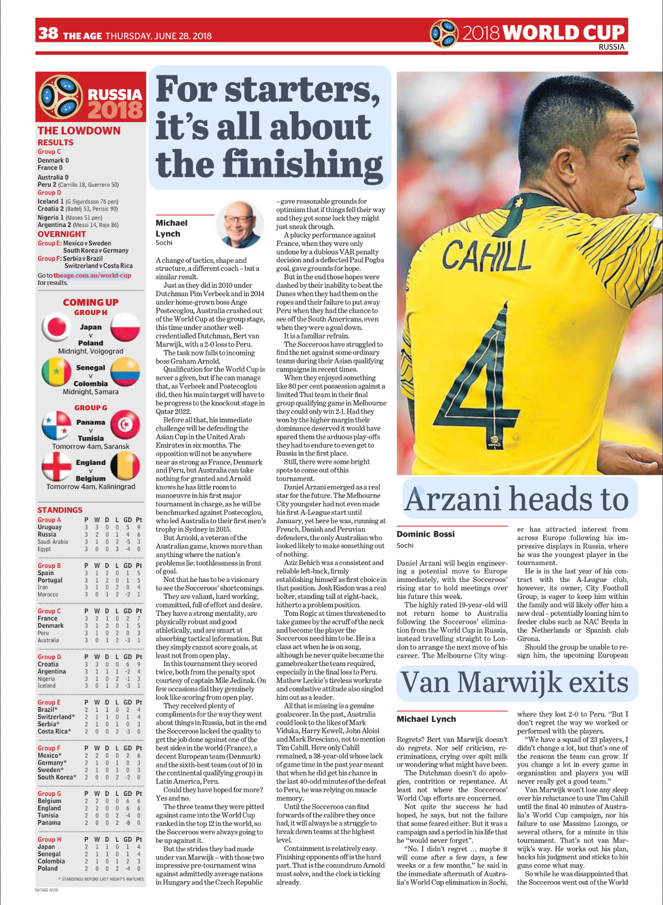 A soccer player wearing a yellow jersey with the name 'Cahill' and number '4' on the back, celebrating during a 2018 World Cup match in Russia.