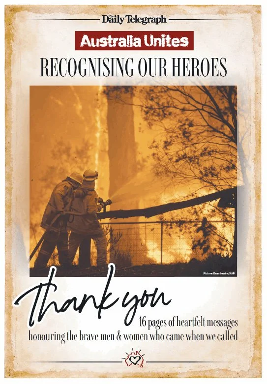 A newspaper page titled 'Recognising Our Heroes' with a photo of two firefighters battling a large wildfire at dusk or dawn. The page includes a message of gratitude for courageous firefighters with text reading 'Thank you' and mentions 16 heartfelt 