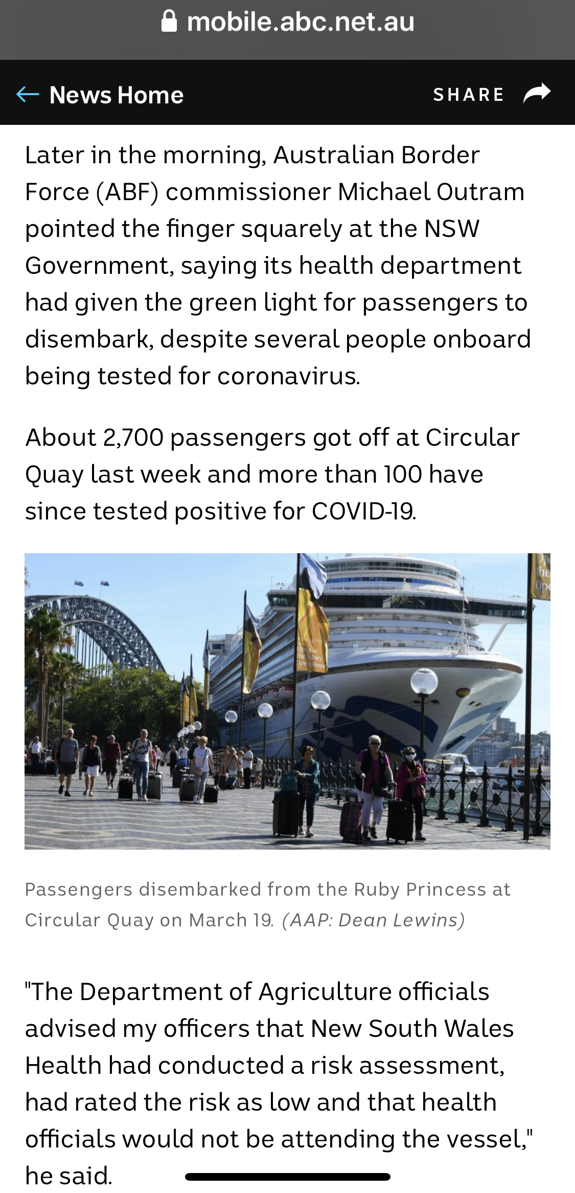 Passengers disembarking from the cruise ship Ruby Princess at Circular Quay on March 19, with people walking along the quay carrying luggage and wearing masks.