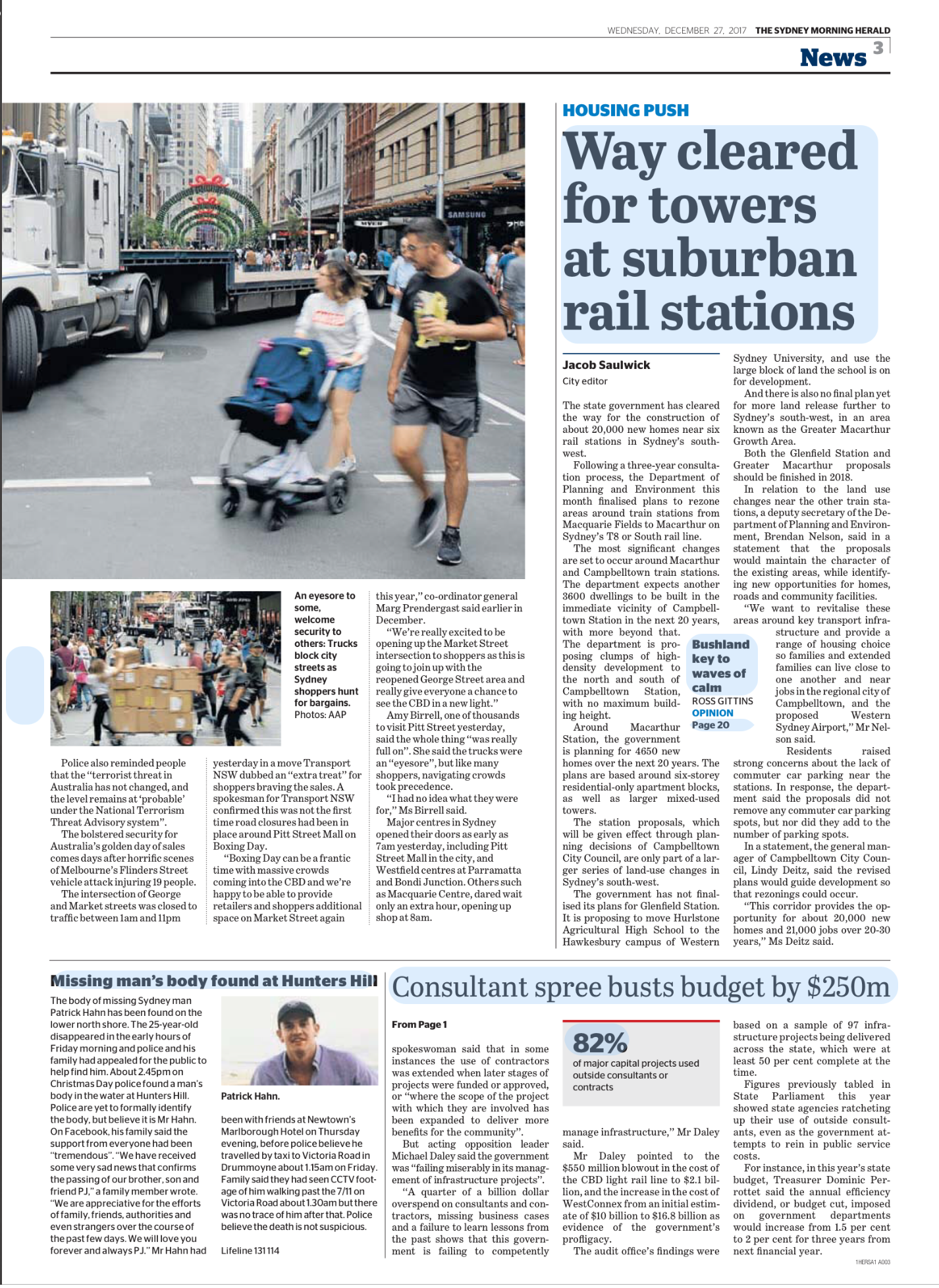 A busy city street with pedestrians, including a man and a girl pushing a stroller, and a large truck in the background with holiday decorations