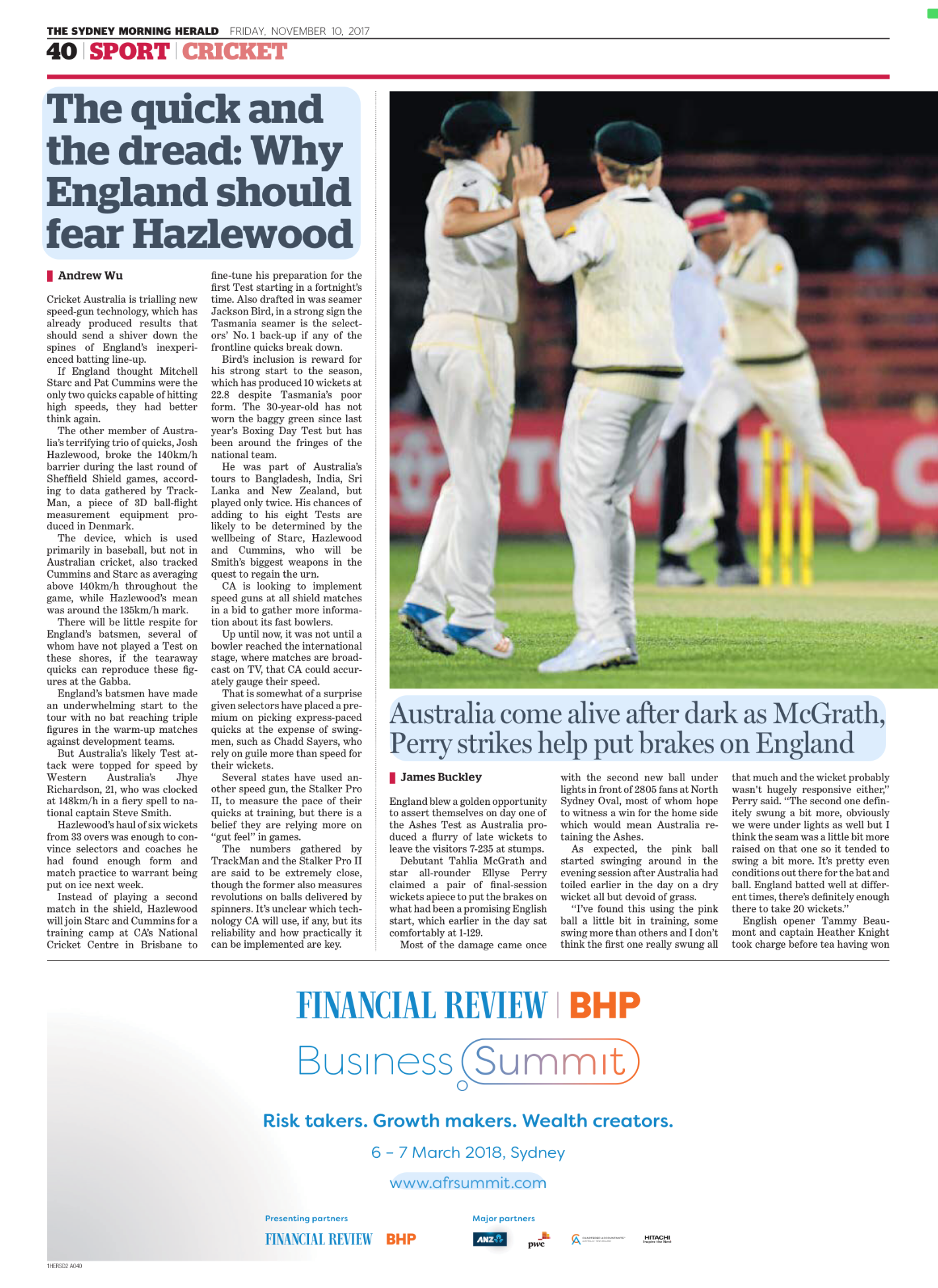 A cricket game with players in white uniforms on a field, some giving high fives, and wickets set up behind them.