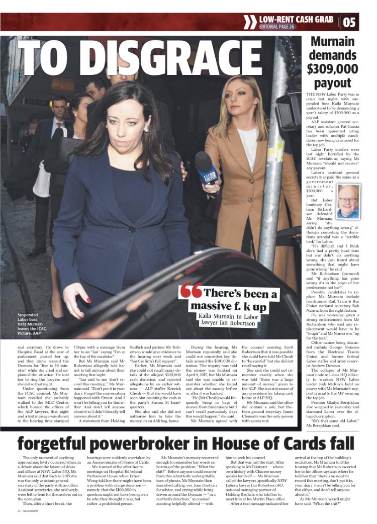 A woman in a navy blazer walking past reporters and photographers outside, with a woman holding a microphone nearby.