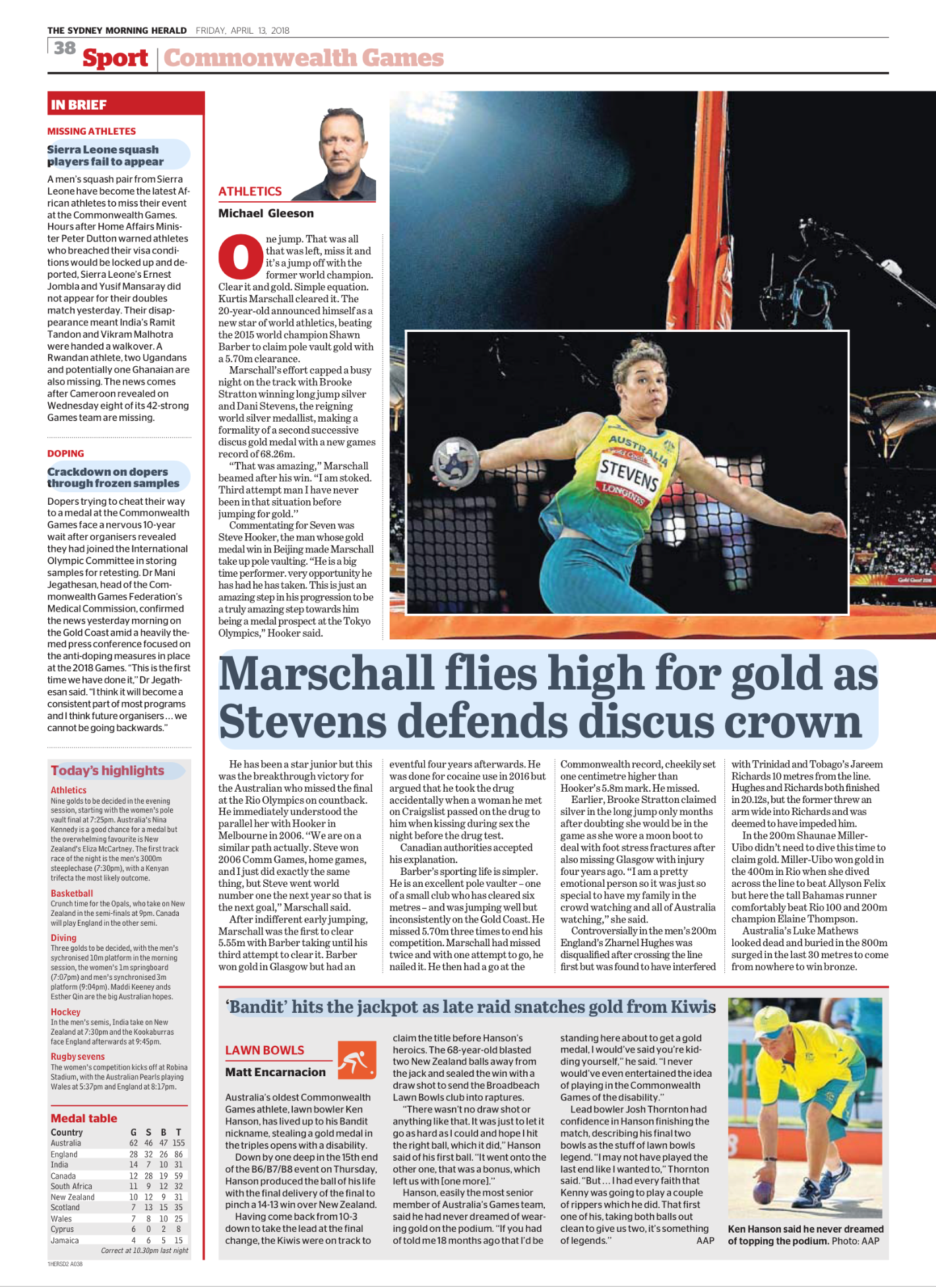 Newspaper sports section with a photo of an athlete competing in a shot put event at the Commonwealth Games, wearing a yellow and green uniform with the name "Stevens" on it, in front of a dark background with audience and stadium lights.