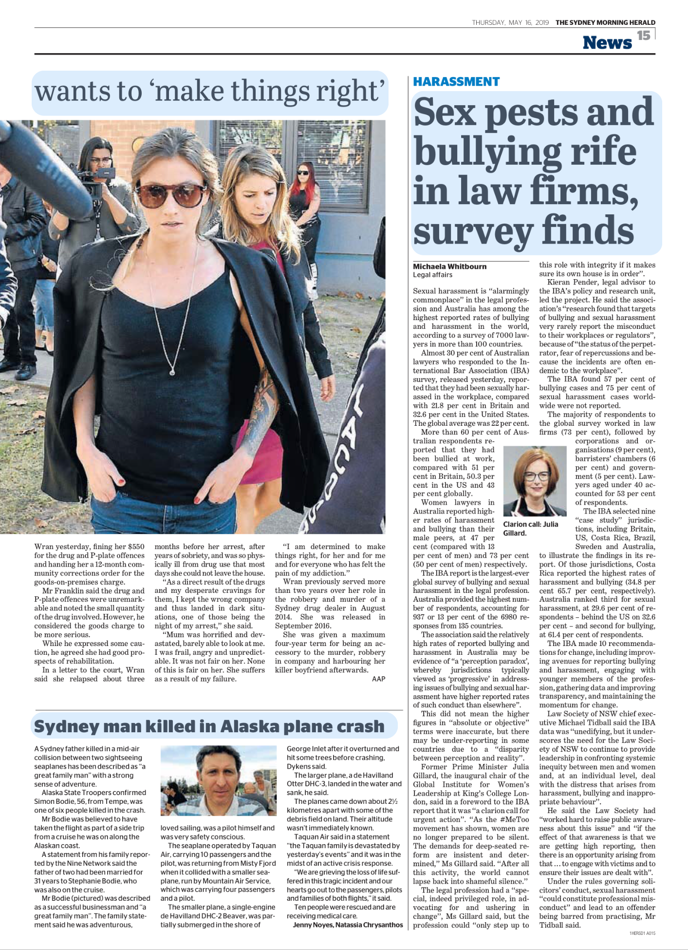 A woman with sunglasses walking outdoors, wearing a black shirt, with other people in the background.