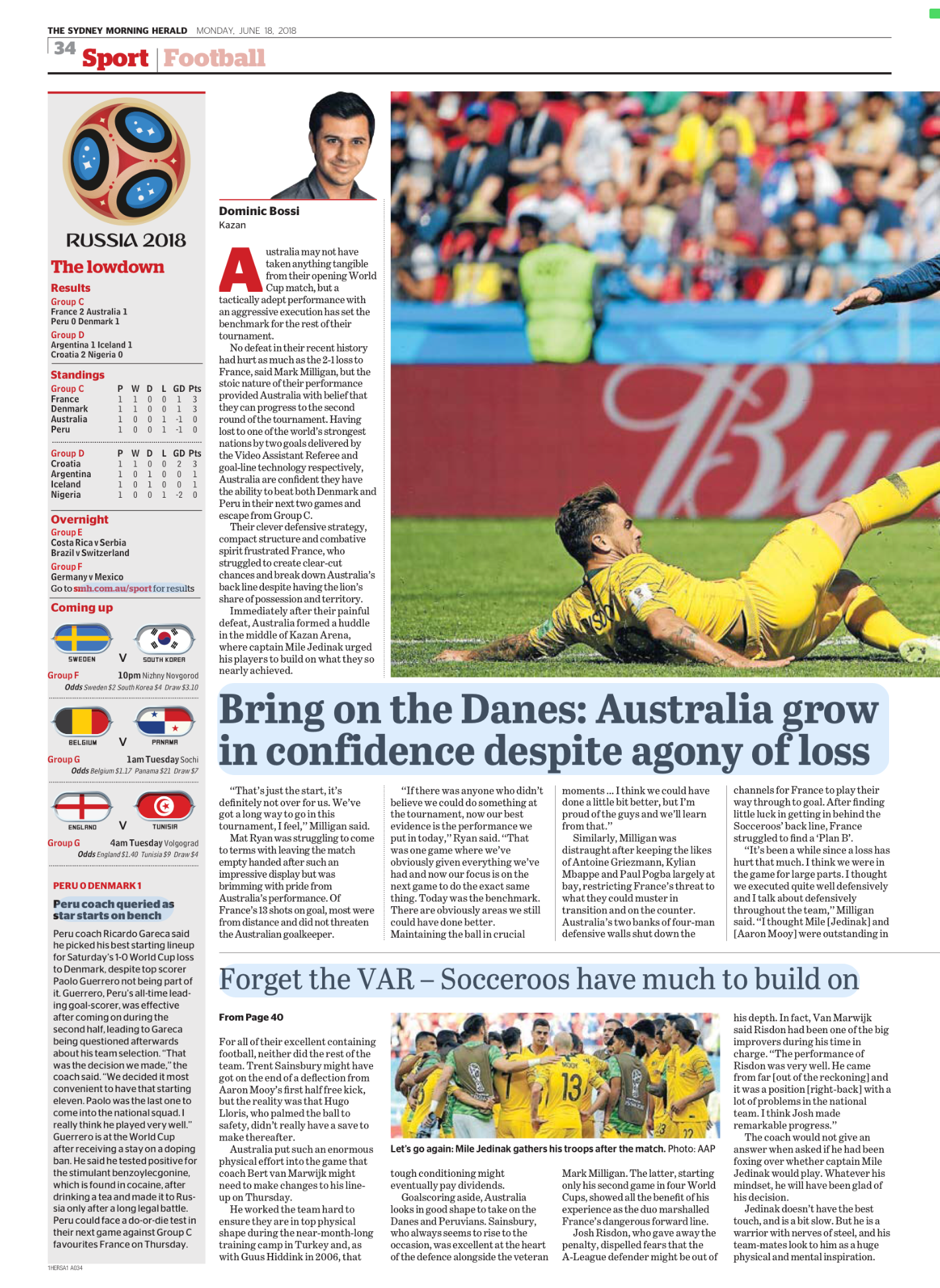 Newspaper sports article about the 2018 FIFA World Cup, featuring a photograph of Australian soccer player Mile Jedinak on the field after a match, with a crowd in the background.