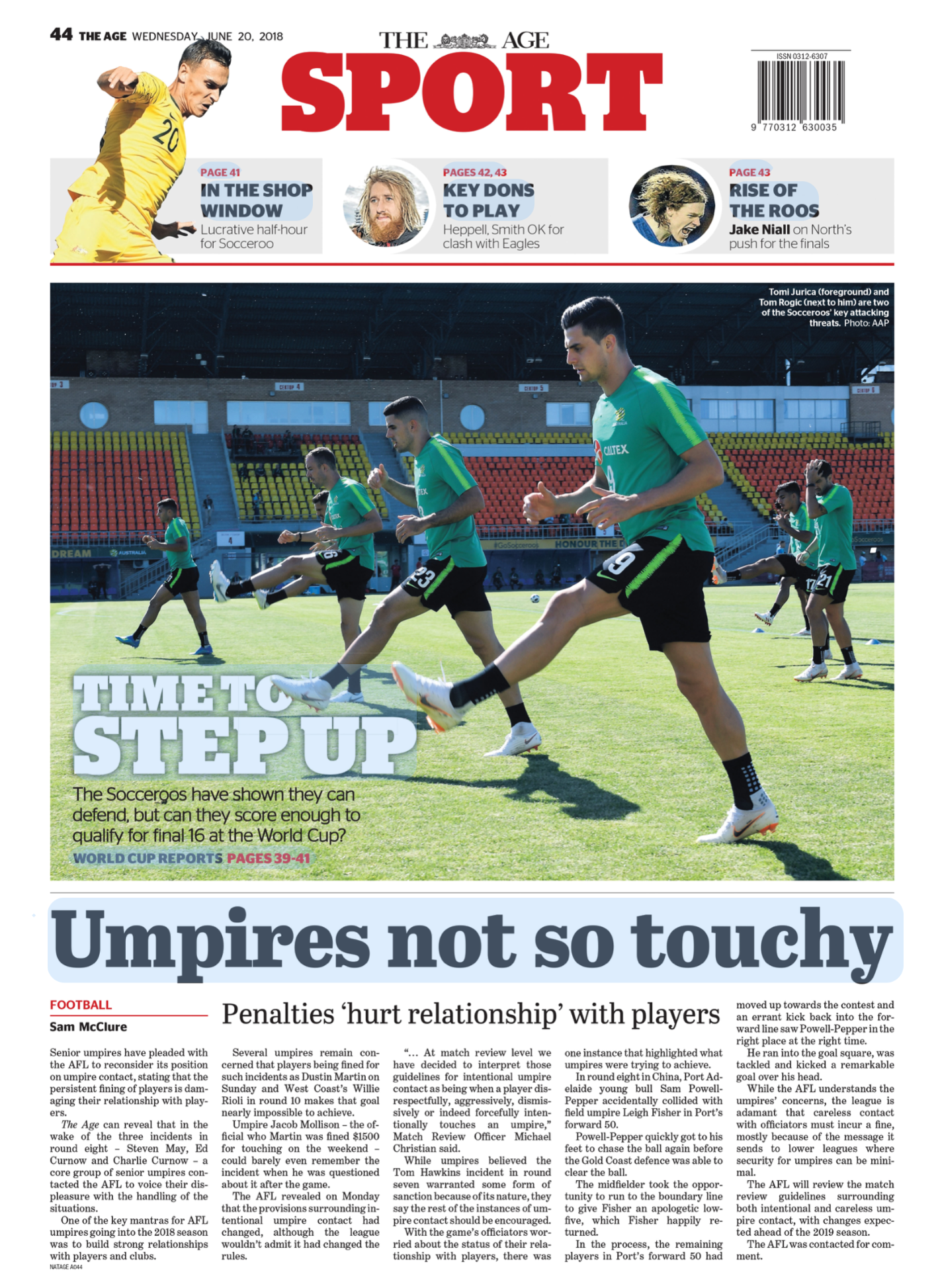 The front page of a sports newspaper from June 20, 2018, featuring a large photograph of soccer players training on a field, with headlines about soccer team performances and umpire reviews.
