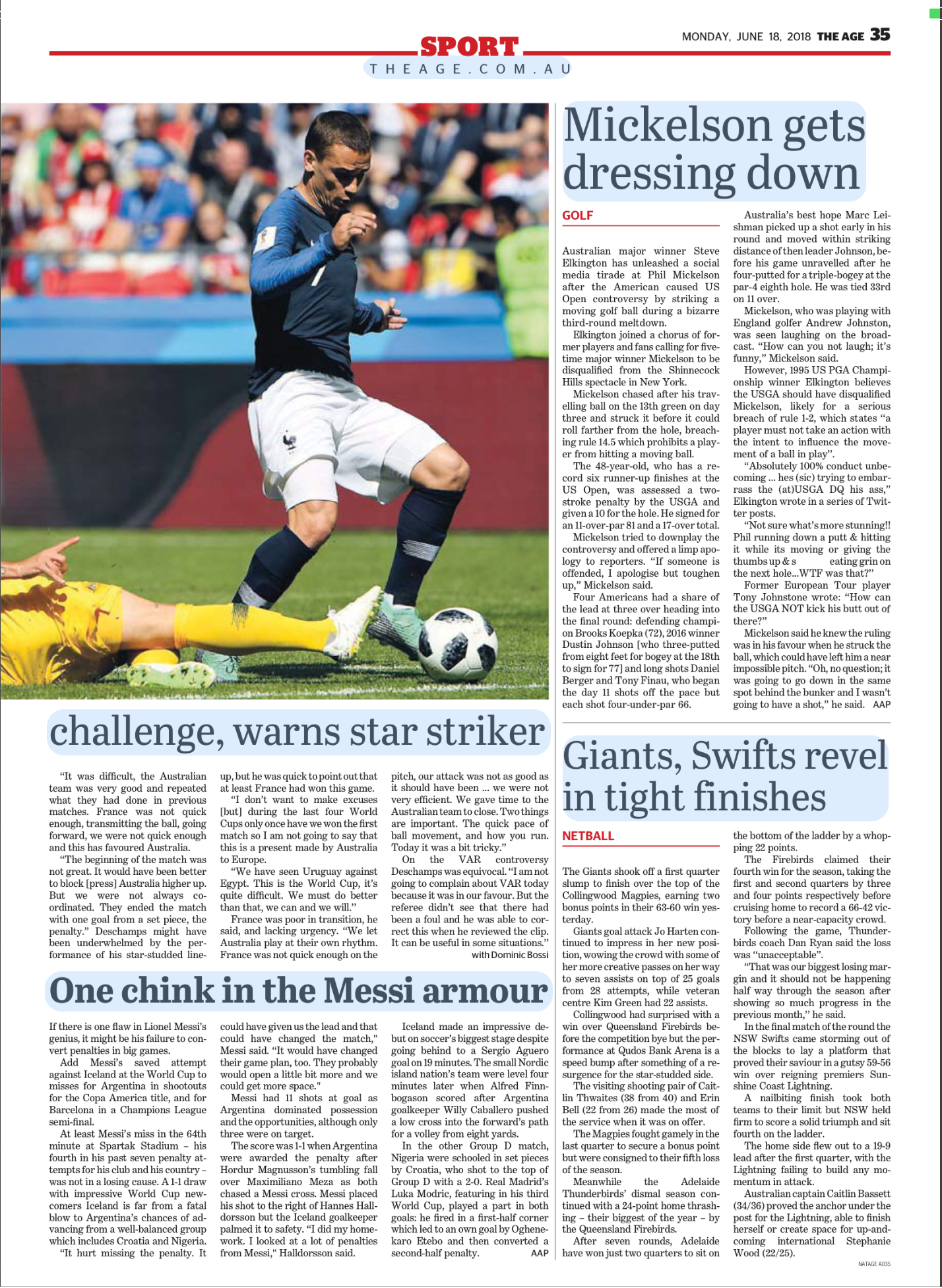 A soccer player in a blue uniform kicks a ball during a match, with a goalkeeper in yellow diving on the ground trying to save