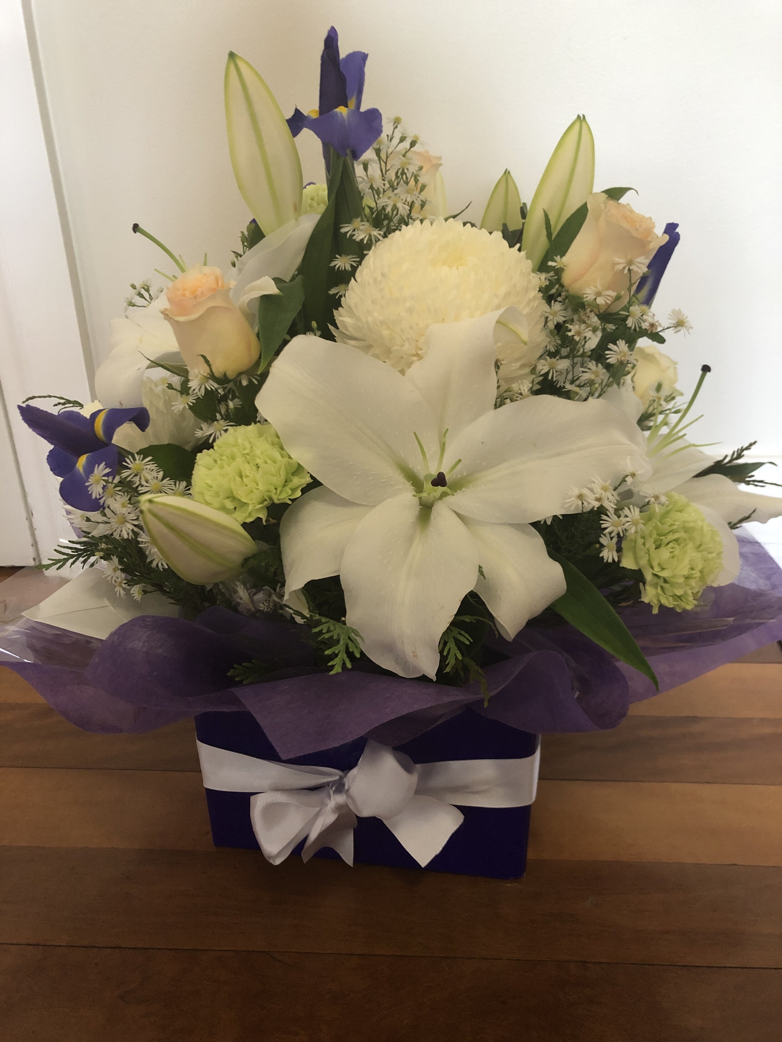 Box arrangement of Iris, Roses, Disbuds and Lilies