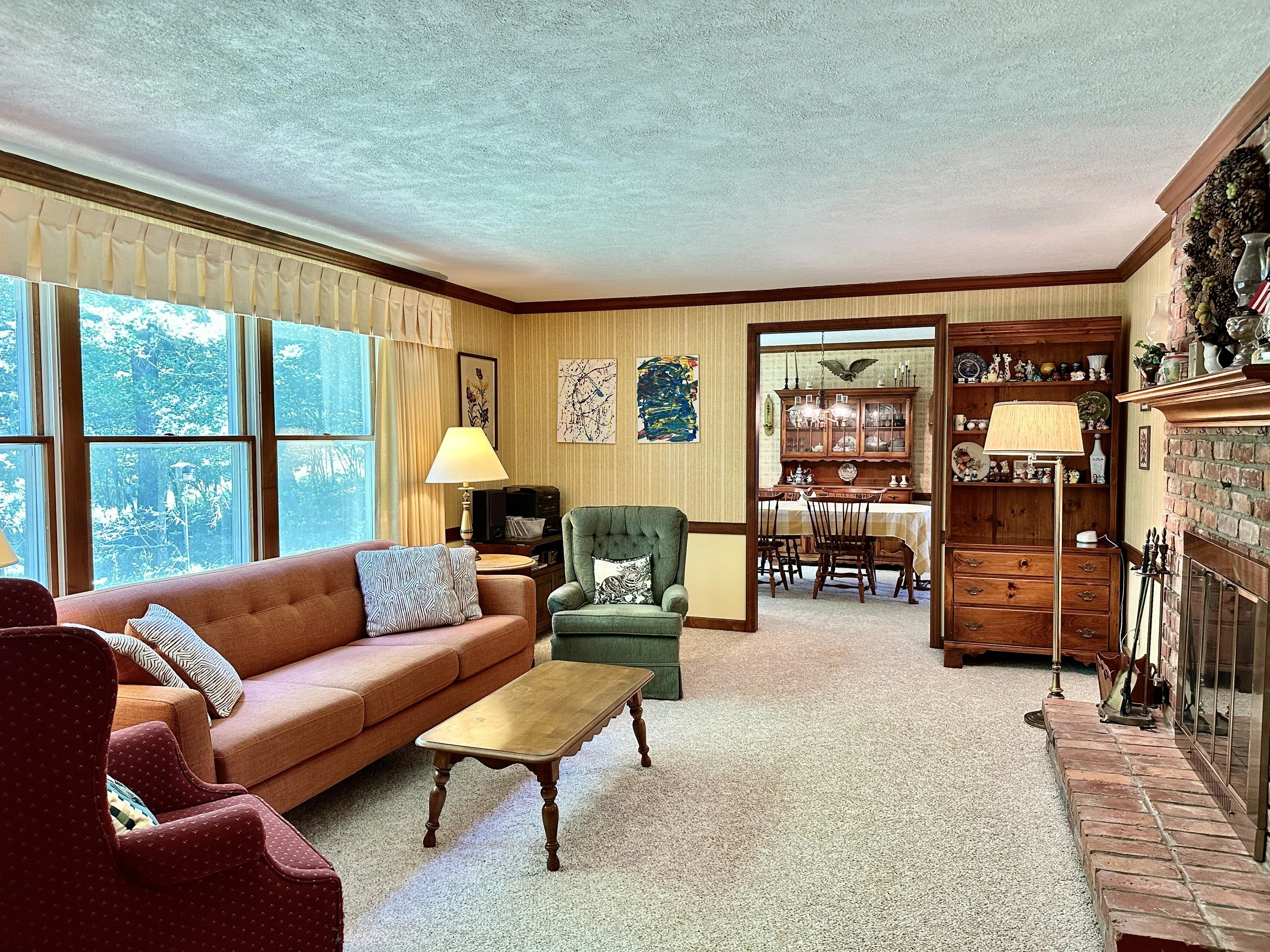 The Living room has windows overlooking the private backyard & wooded setting with no rear neighbors