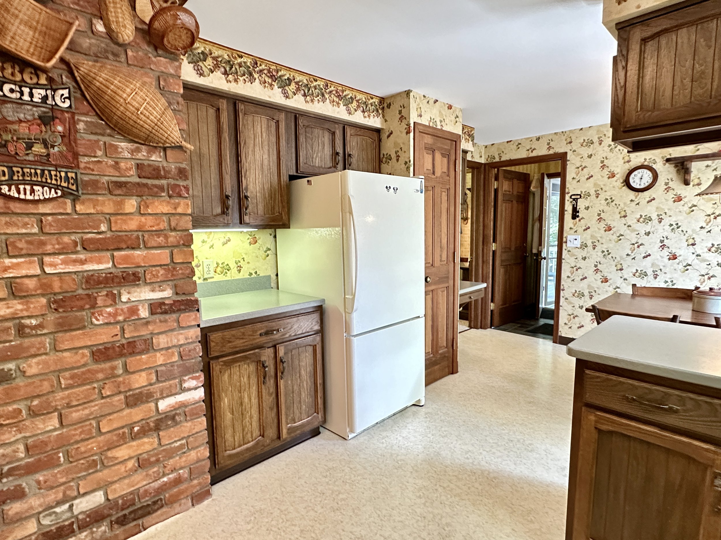 View of the pantry & warm brick wall, backside of the fireplace