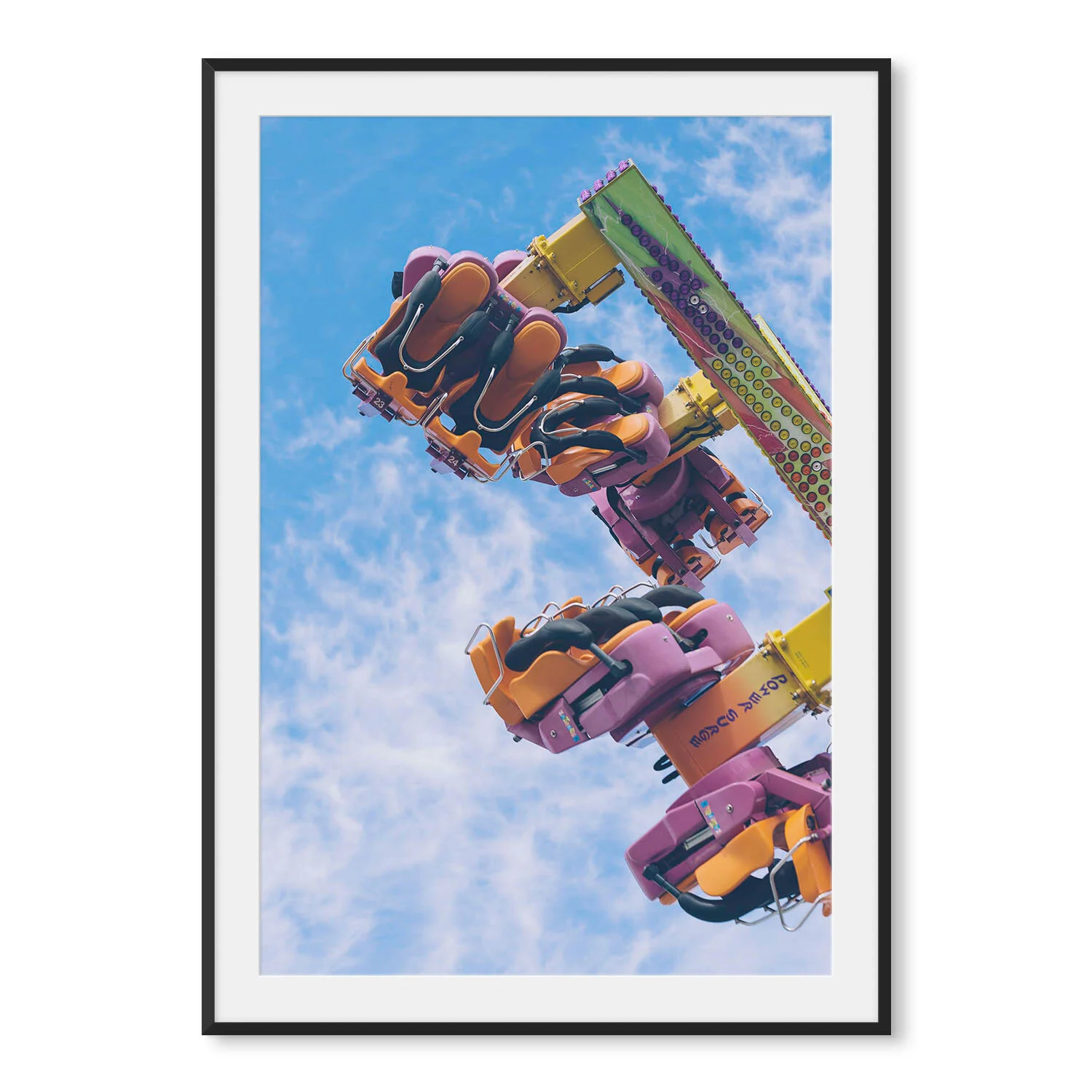 Matte black aluminum framed vertical fine art photography of the orange seats and blinking lights of a carnival ride twirling above the midway.