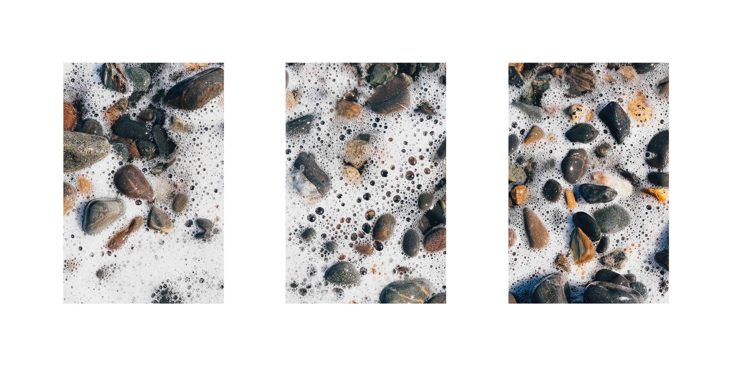 Unframed mounted triptych fine art photography of beach stones poking through the bubbles of crashing waves.