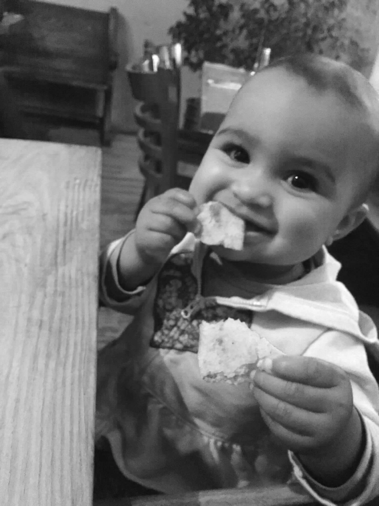 baby-snacking-on-bread-at-table.jpg