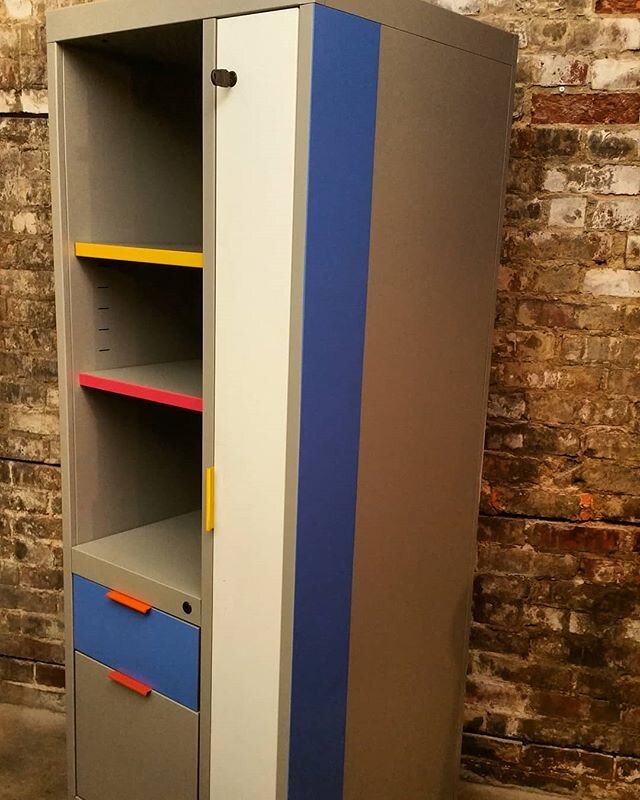 Just in...a lockable , all metal &quot;tower &quot; storage / shelf wall unit with a small armoire, drawers and an adjustable height shelf. It features welded steel construction with a gun metal grey silver body, an off white door and multiple bright