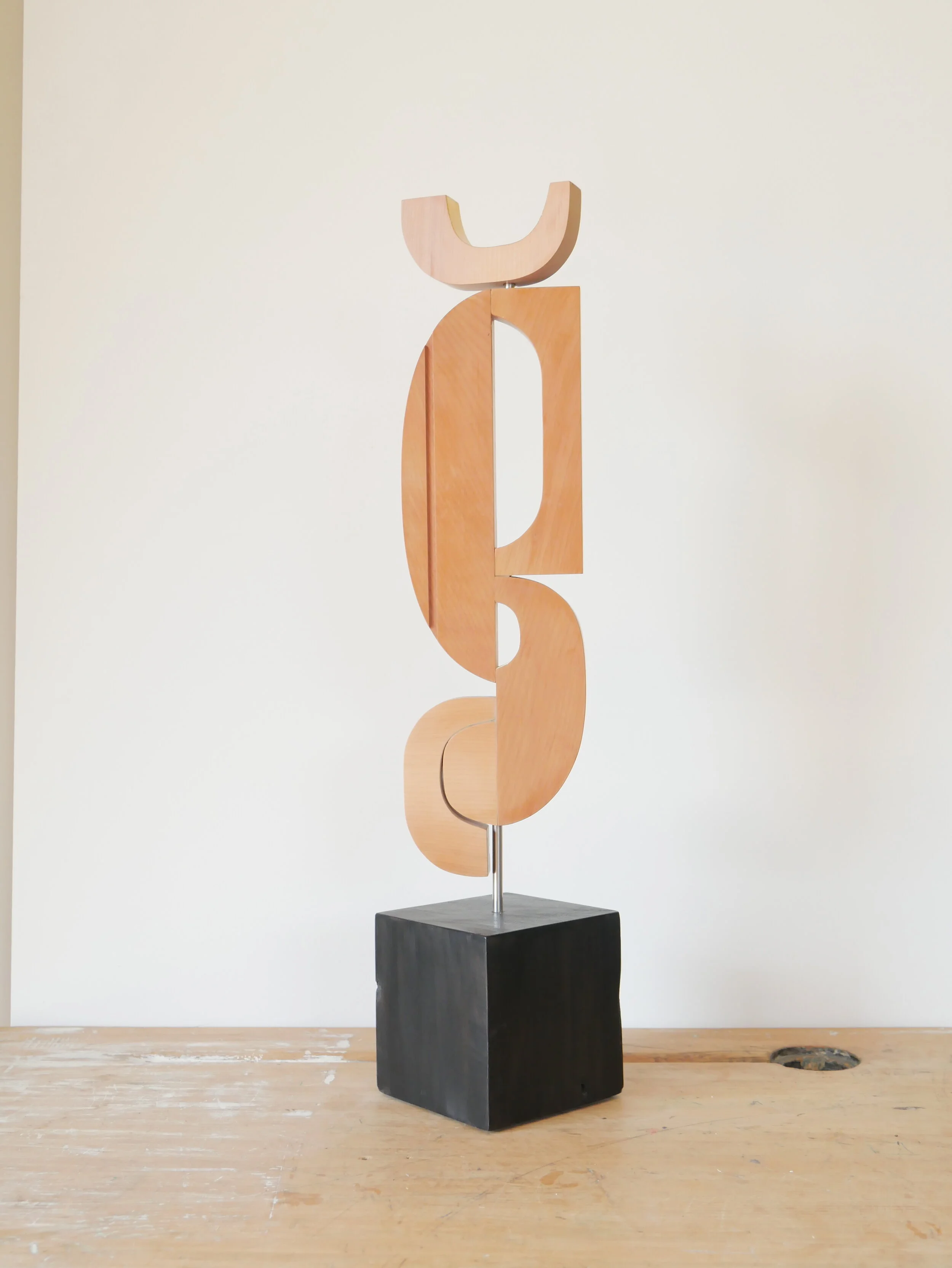Free standing sculpture 'Crescent Totem', made from matai and kauri timber. 