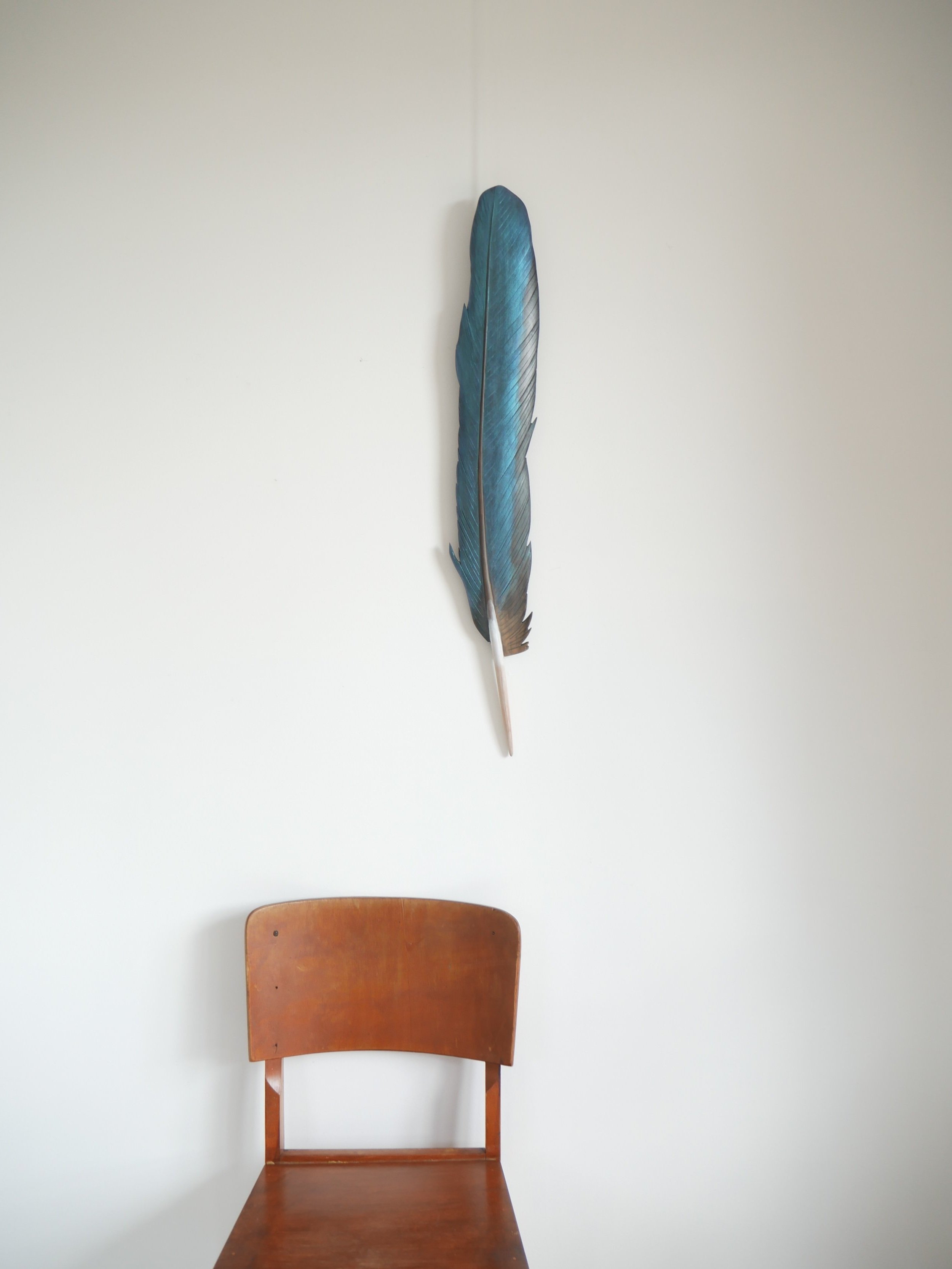 Iridescent turquoise kotare feather art by Claire Jensen Opunake.