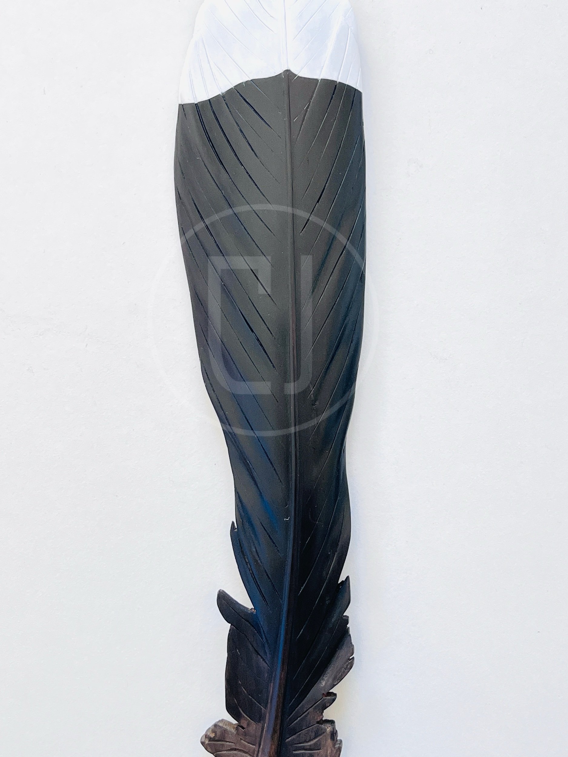 detail carved huia feather claire jensen.jpeg