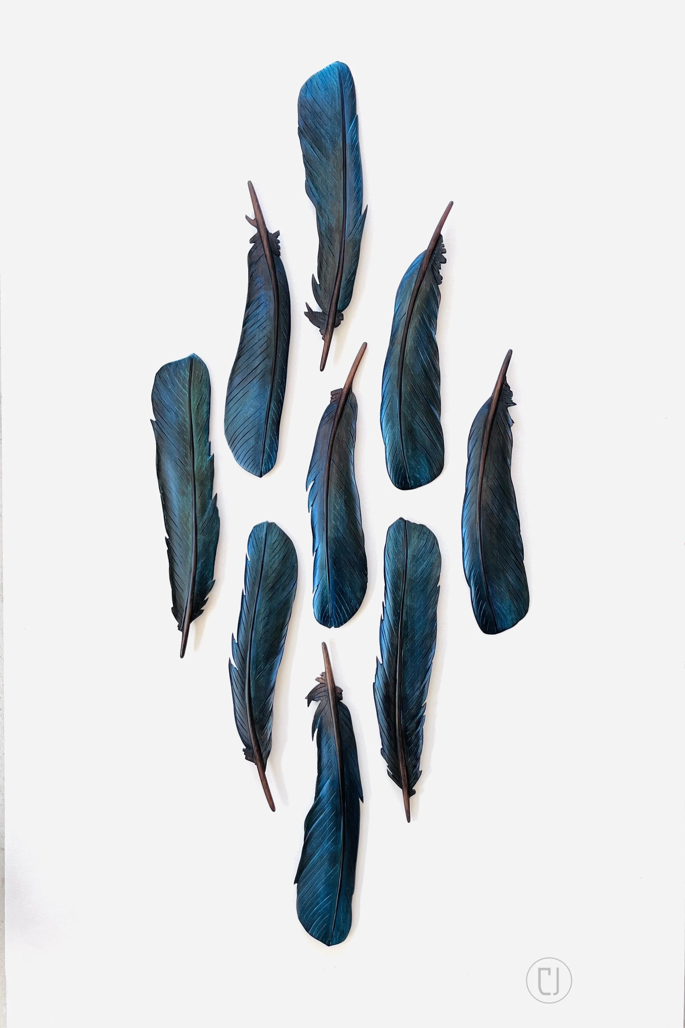 Carved tui feather art installation by Claire Jensen NZ. 