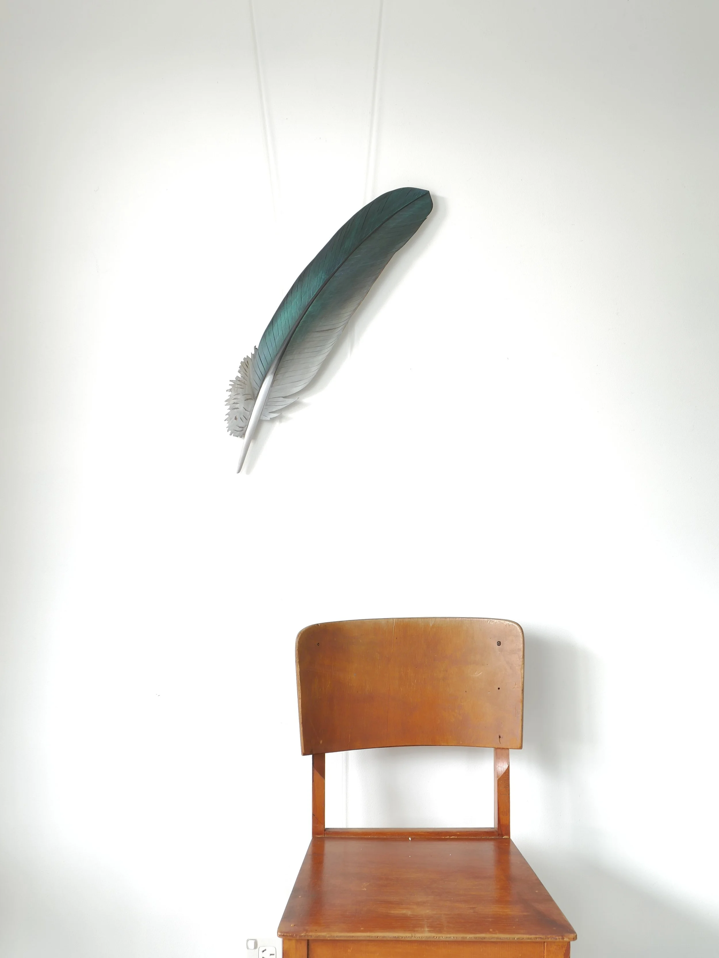 Large scale kereru feather carving with iridescent green-purple colour. Piece measures 60cm long and is designed as wall sculpture. A bespoke commission made 2025. 