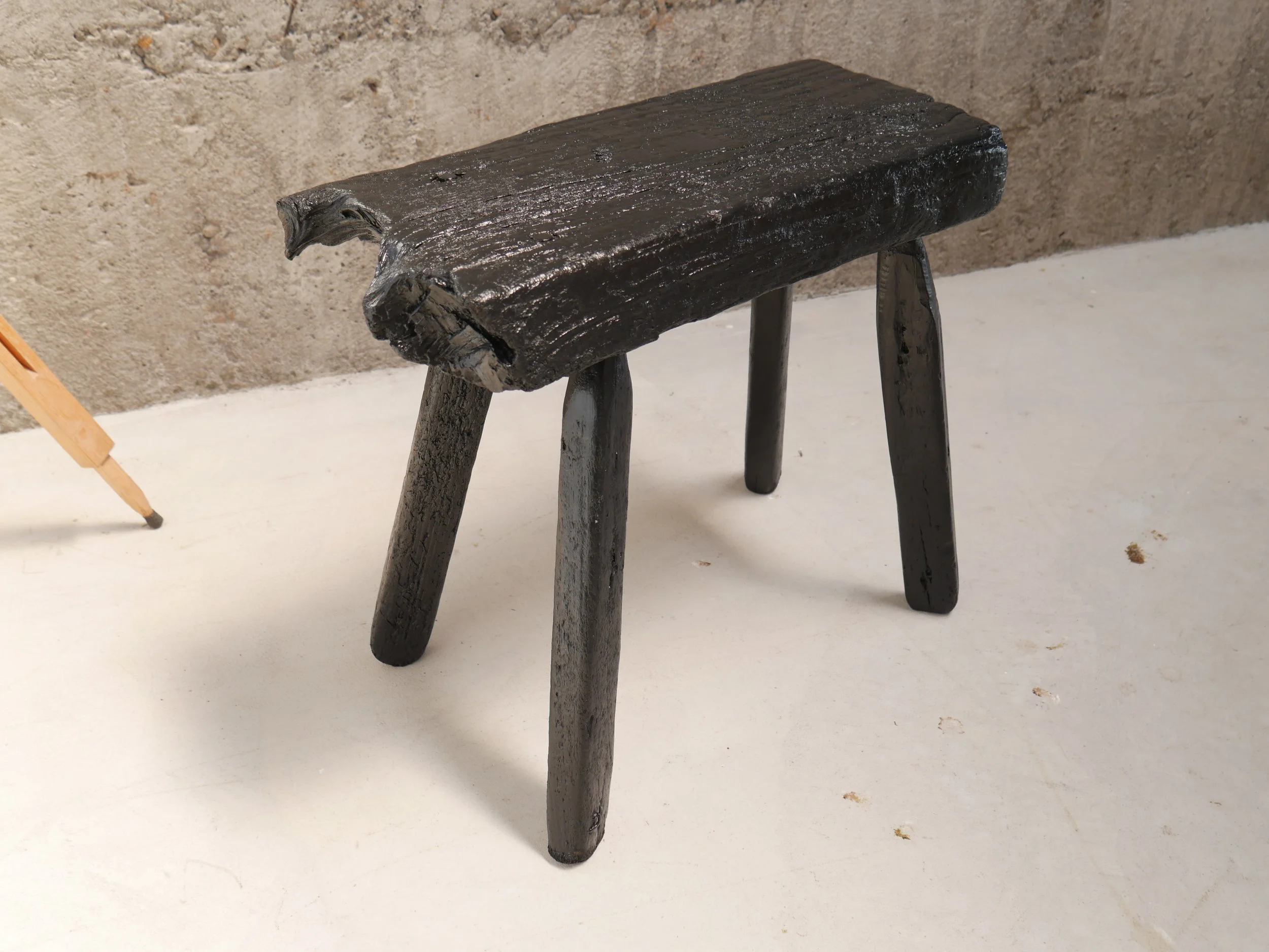 Blackened milking stool, made for wastemedia design 2018. Salvaged beach timber, acrylic paint. 