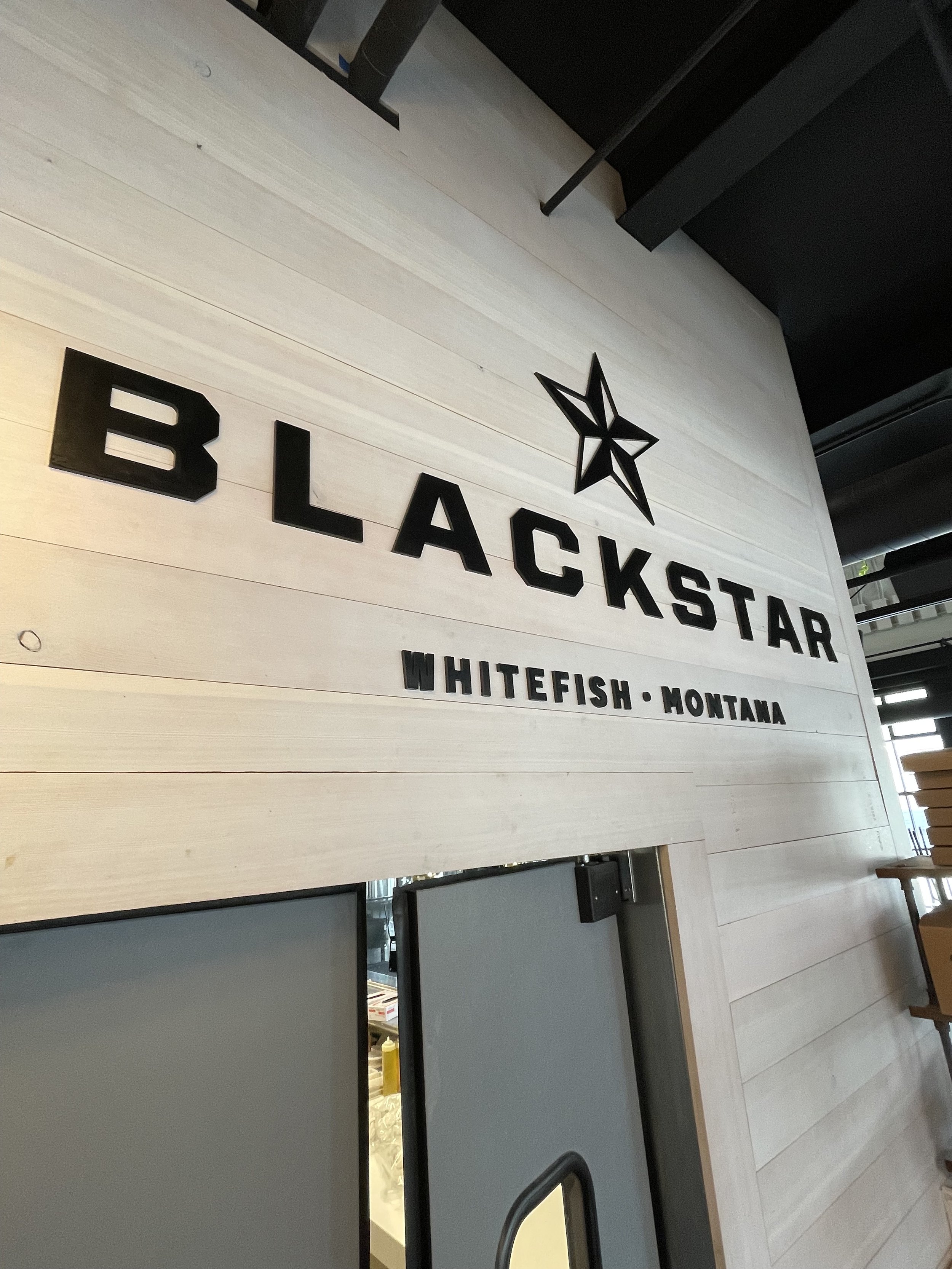 Custom 1/4" steel sign finished with a black magic patina for Blackstar in Whitefish Montana.