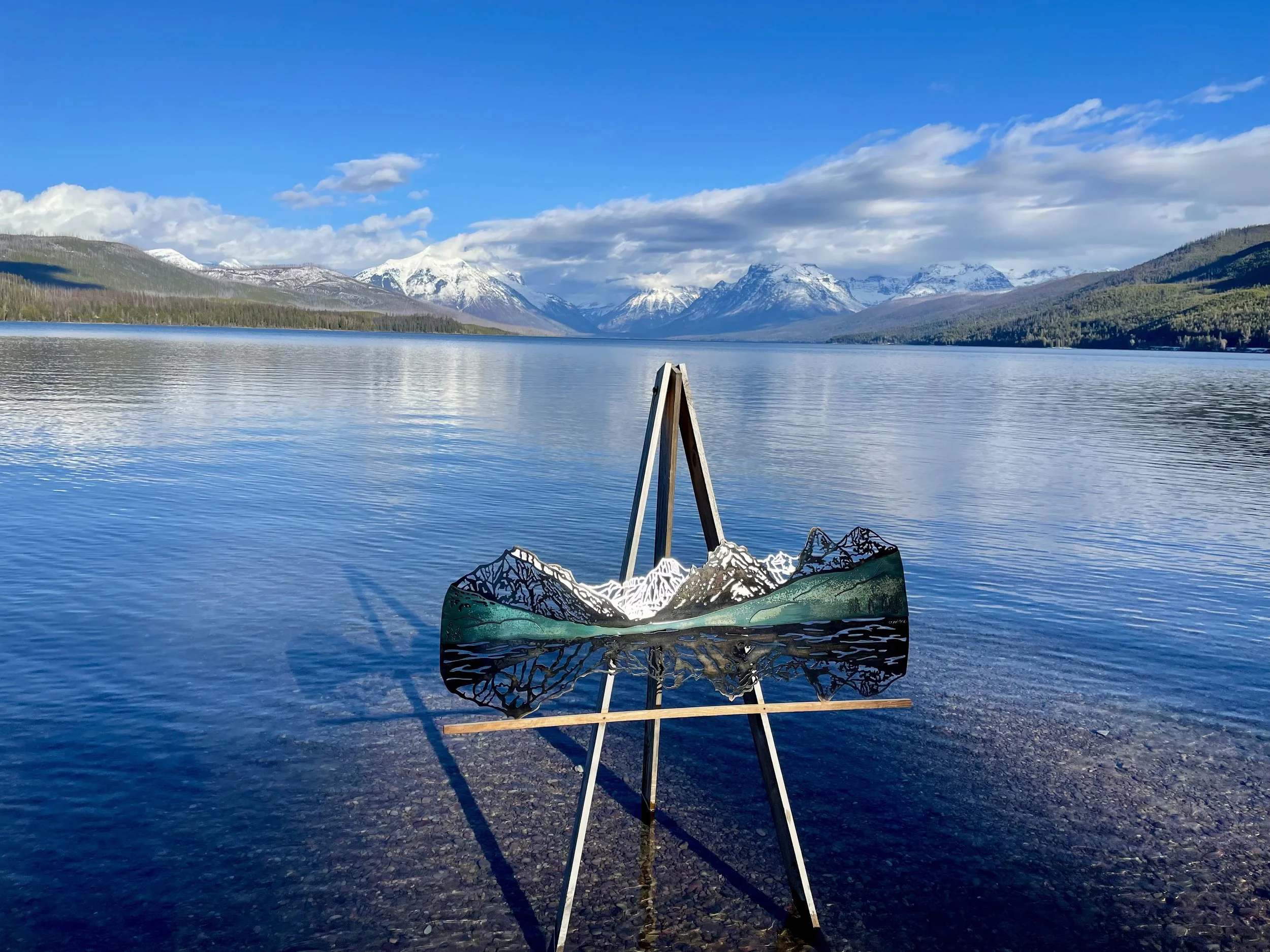 Creative Combinations Montana's original art work of a triple layer steel wall art of the Lake McDonald mountains in Glacier National Park on the shore of the lake.