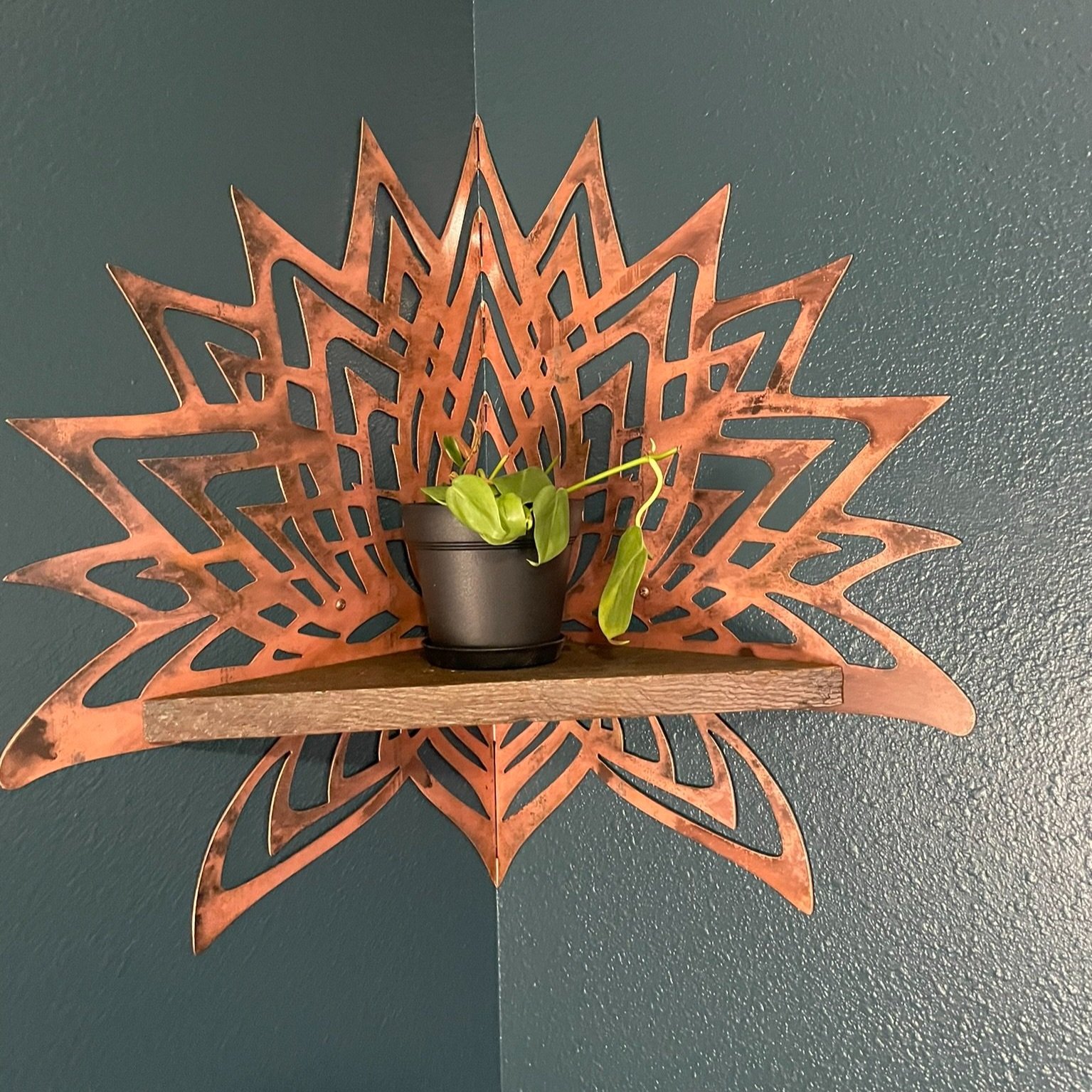 Photo of Creative Combinations Montana's Thousand Petal Lotus Steel and Wood Corner Shelf, finished with a copper patina finish and barnwood shelf.