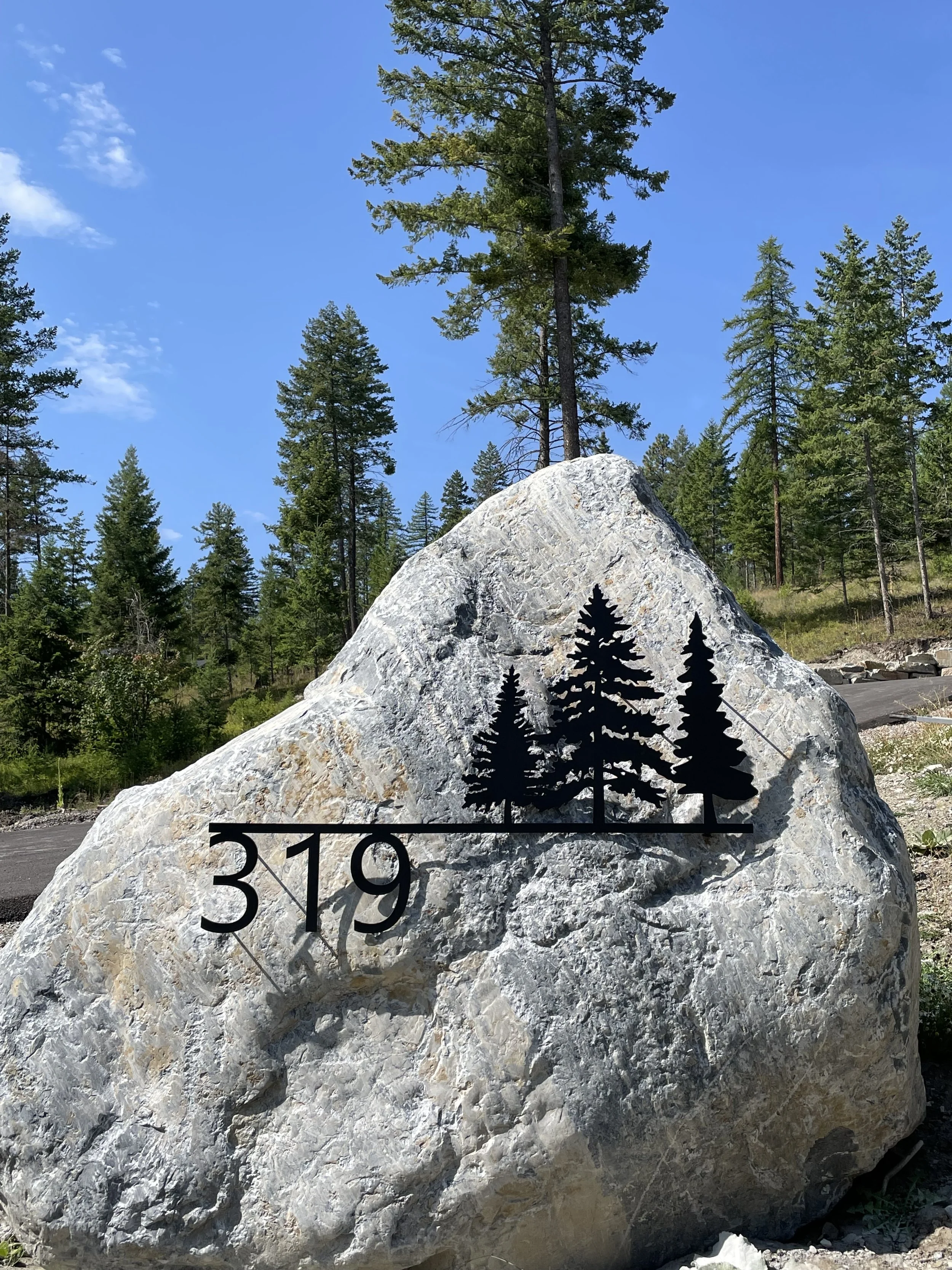 Custom metal address sign mounted into a landscape rock.jpeg