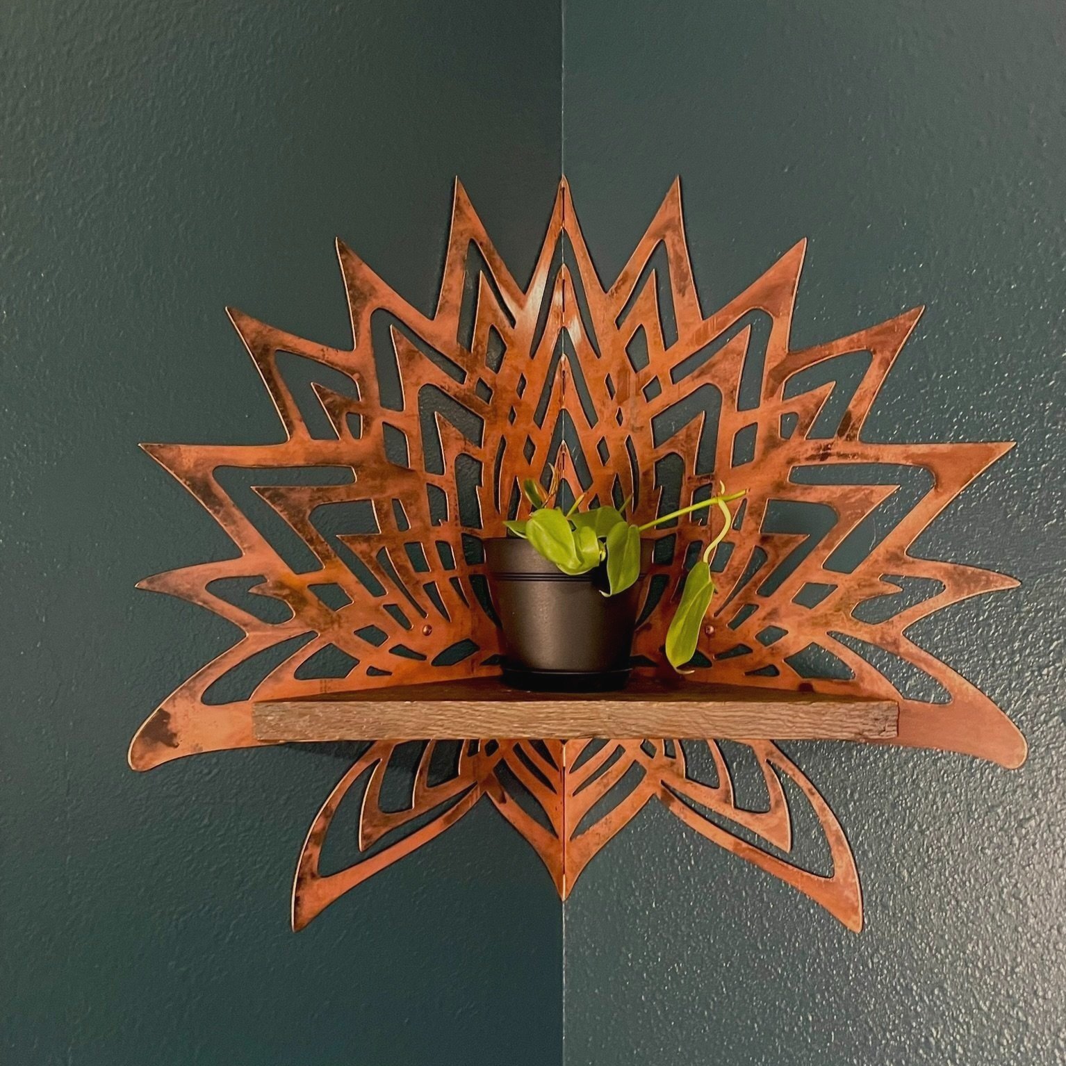 Photo of Creative Combinations Montana's Thousand Petal Lotus Steel and Wood Corner Shelf, finished with a copper patina finish and barnwood shelf.