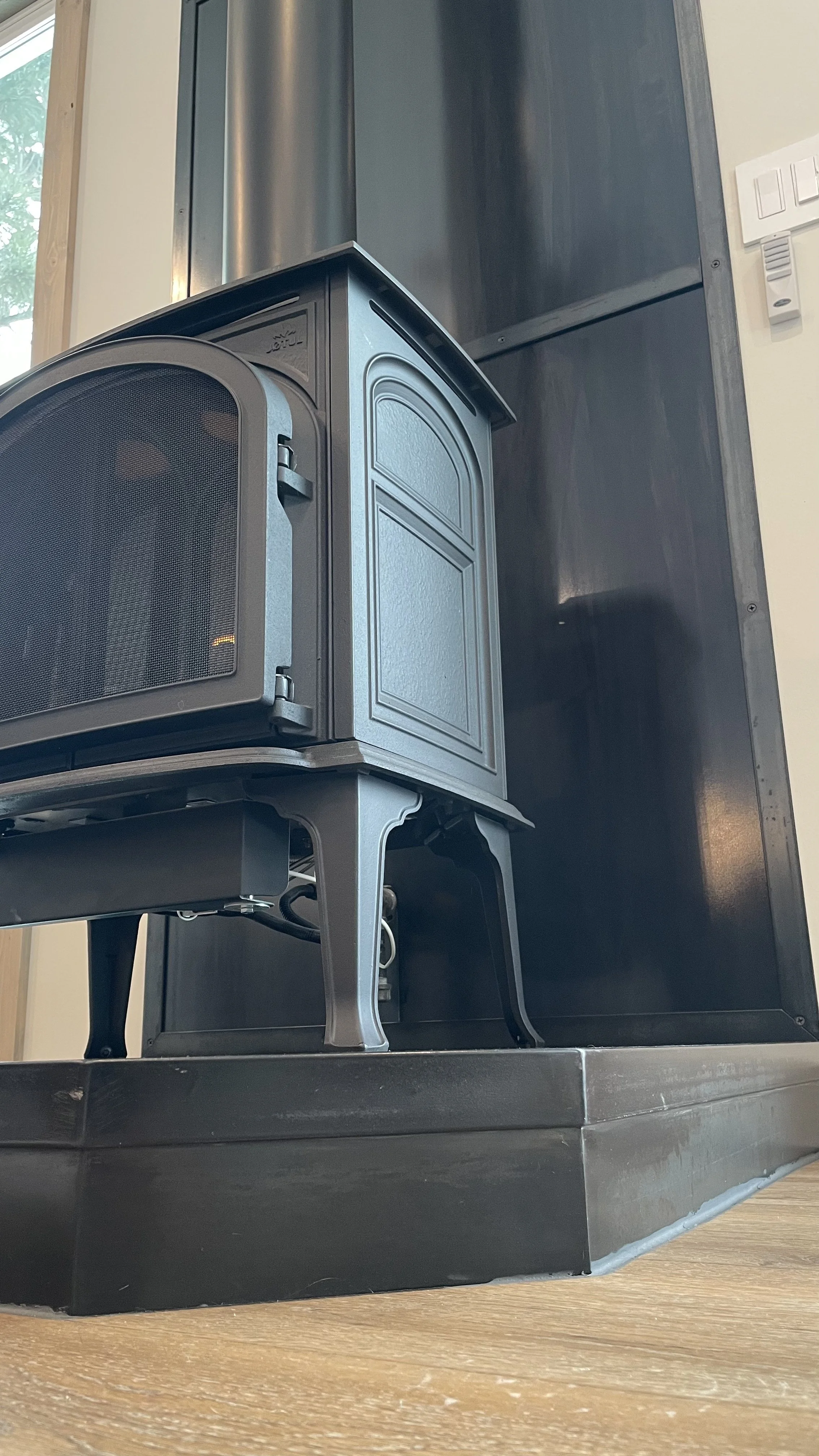 Close-up view of custom steel fire place cladding at showroom and Airbnb Inspiration Cabin, designed, created and hand made steel work by Creative Combinations Montana.