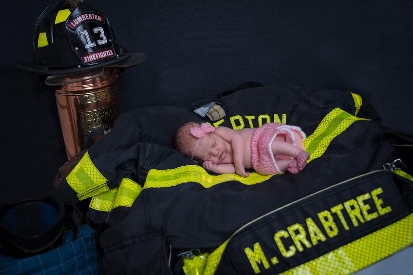  Daddy Marc is a volunteer firefighter at Lumberton.    “Our advice to future parents is to stick with it even if the baby gets fussy!  Some of our best photos came at the end of the shoot once Annabeth had calmed down and cried herself out.” 