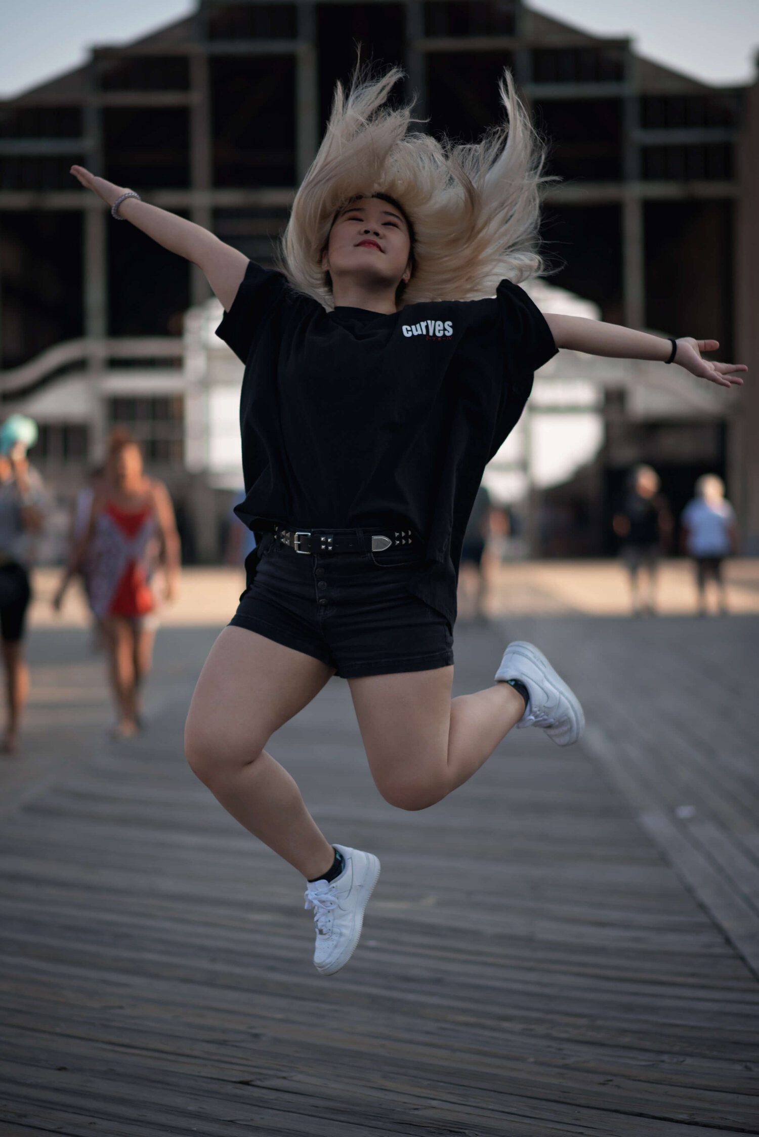 Rutgers Senior Girl jumping at Asbury Park Boardwalk