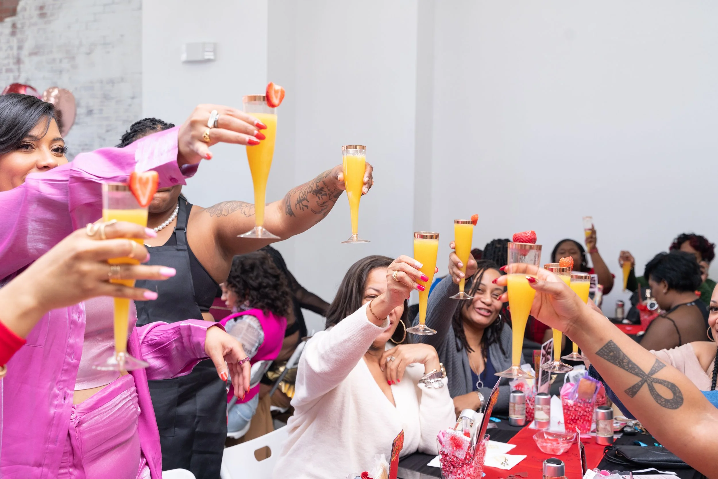 women cheering their glasses