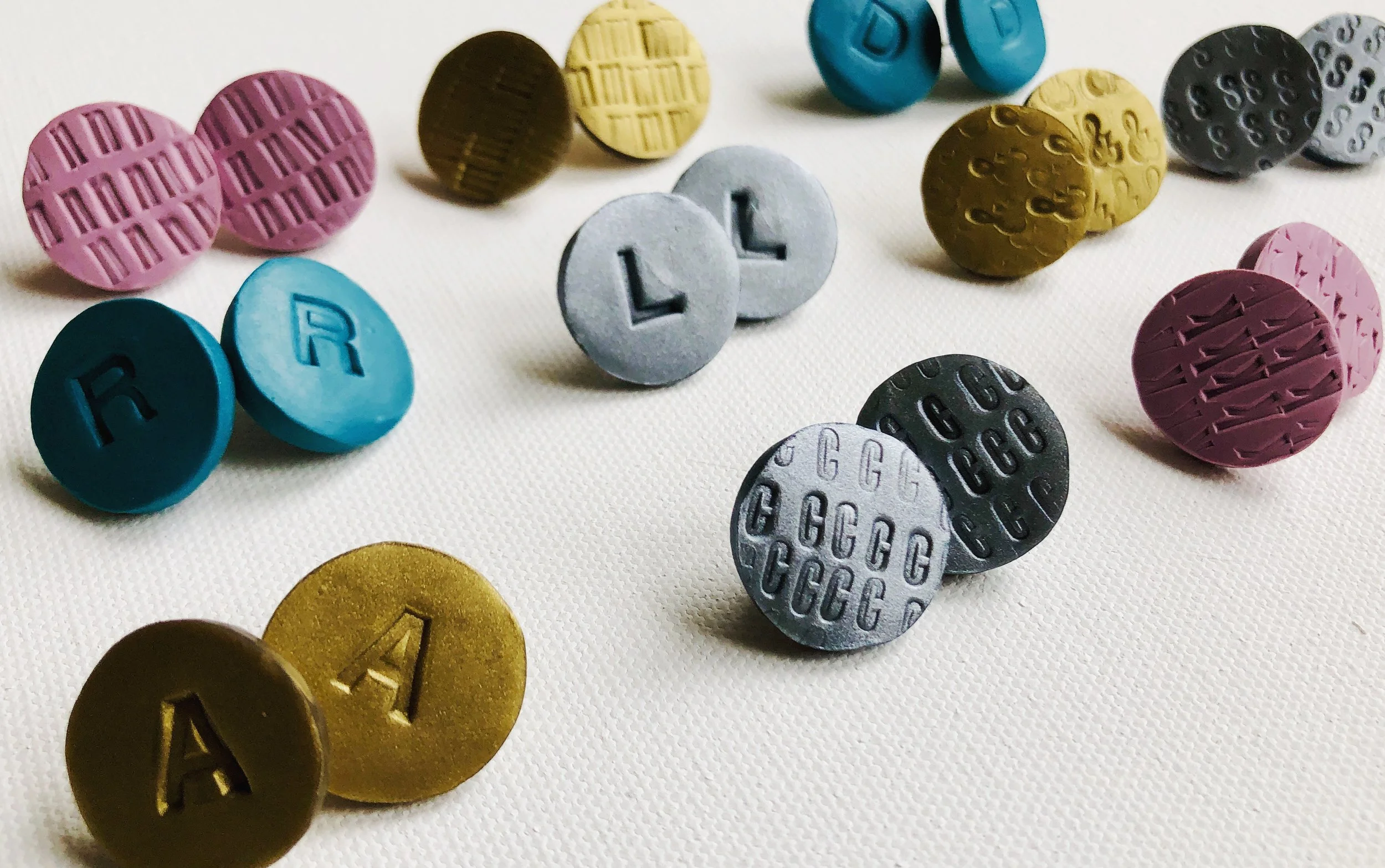 Polymer clay earrings marked with vintage letterpress stamps