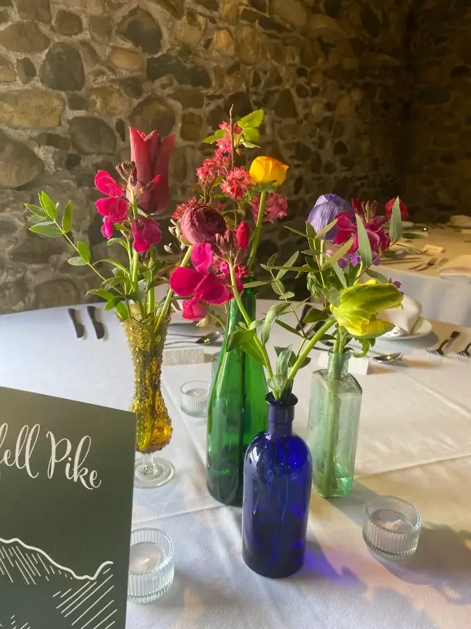  Spring flowers in colourful vases at a wedding 