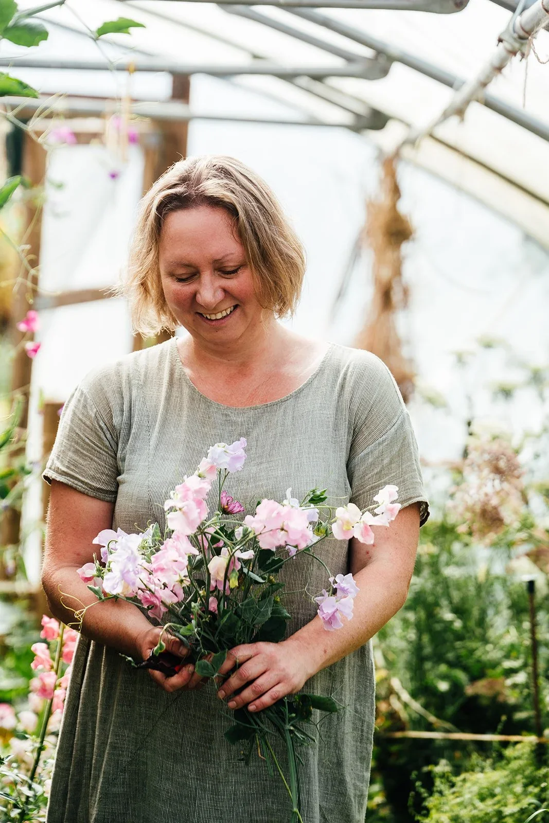 Harriet holding a bunch of pink flowers