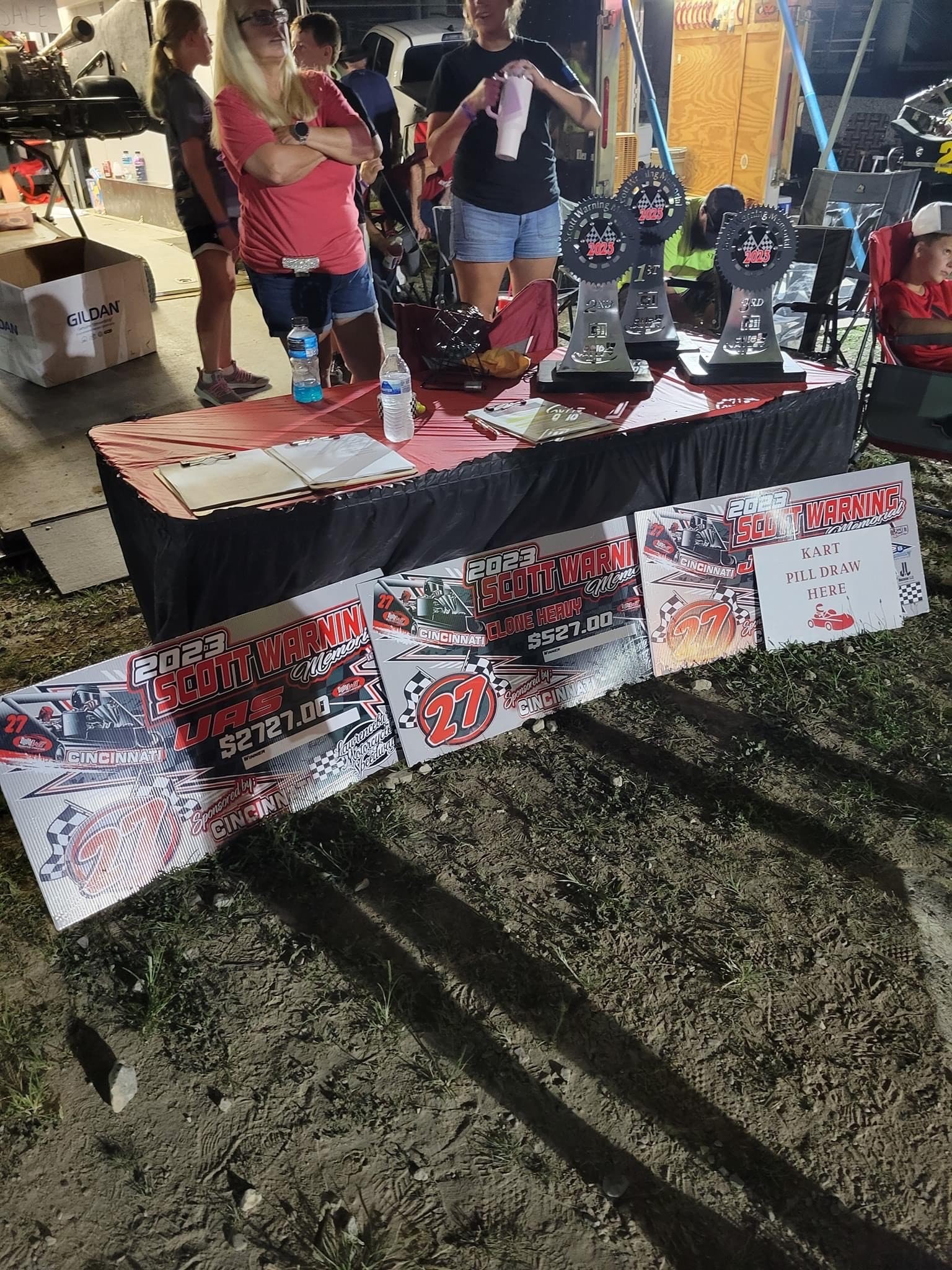  UAS sign in table with trophies and checks for event winners 