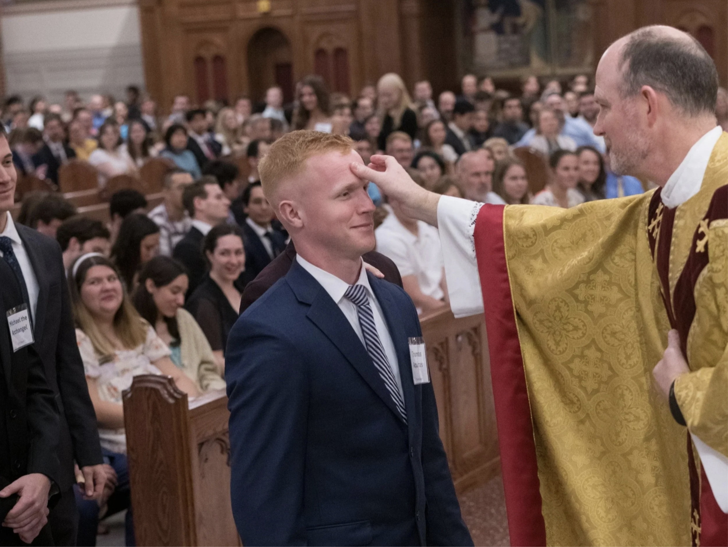 Mason being confirmed by Fr. Will Straten '00