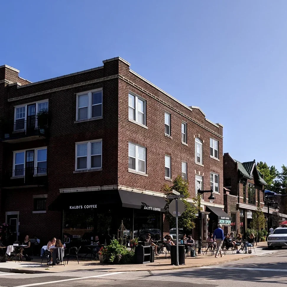 Kaldi's Coffee on DeMun in St. Louis, Missouri, featuring outdoor patio seating and the historic neighborhood streetscape near Rudy's Flower Truck weekend stop.